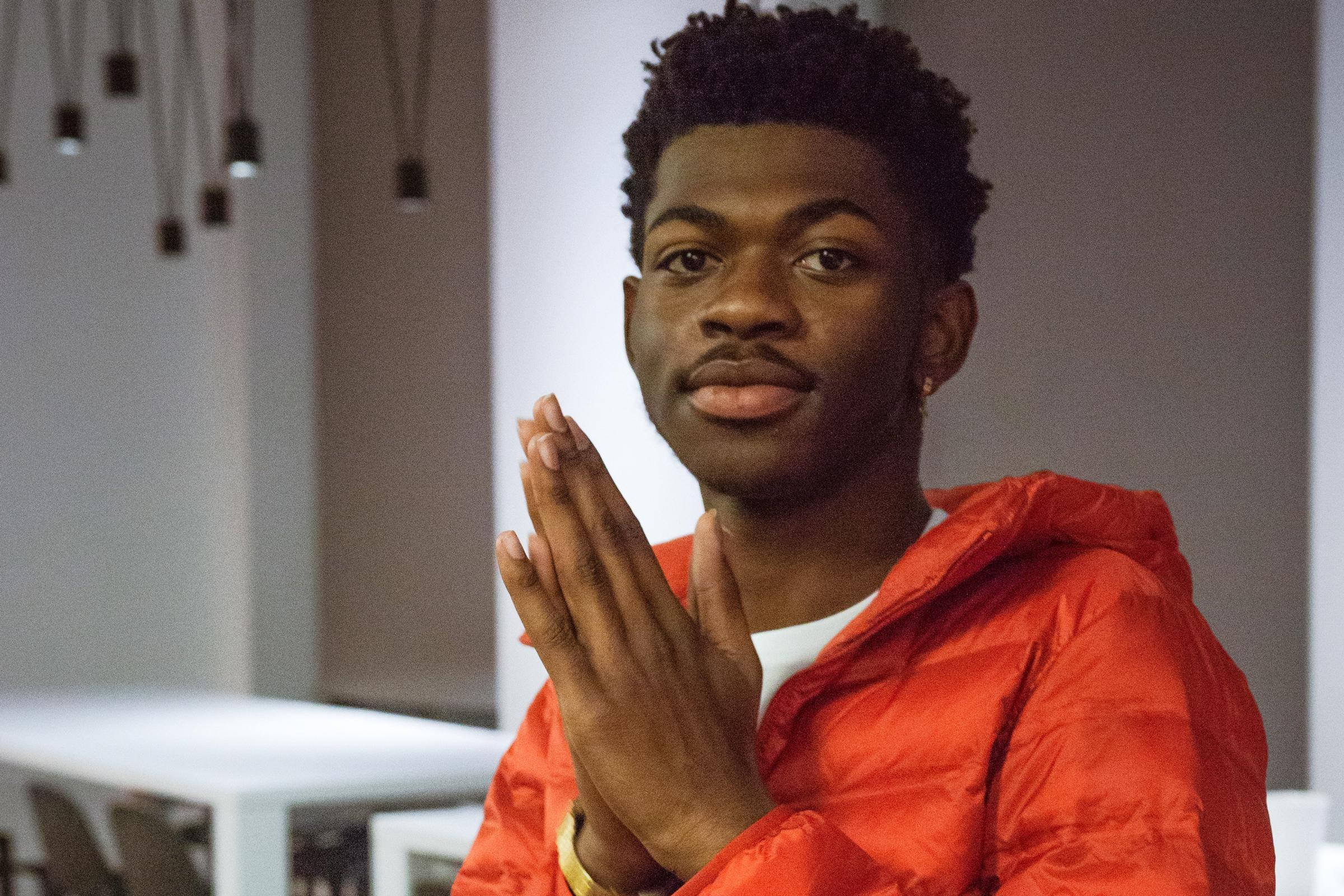Lil Nas X, bright orange puffer jacket, playful expression, Full HD Desktop Wallpaper