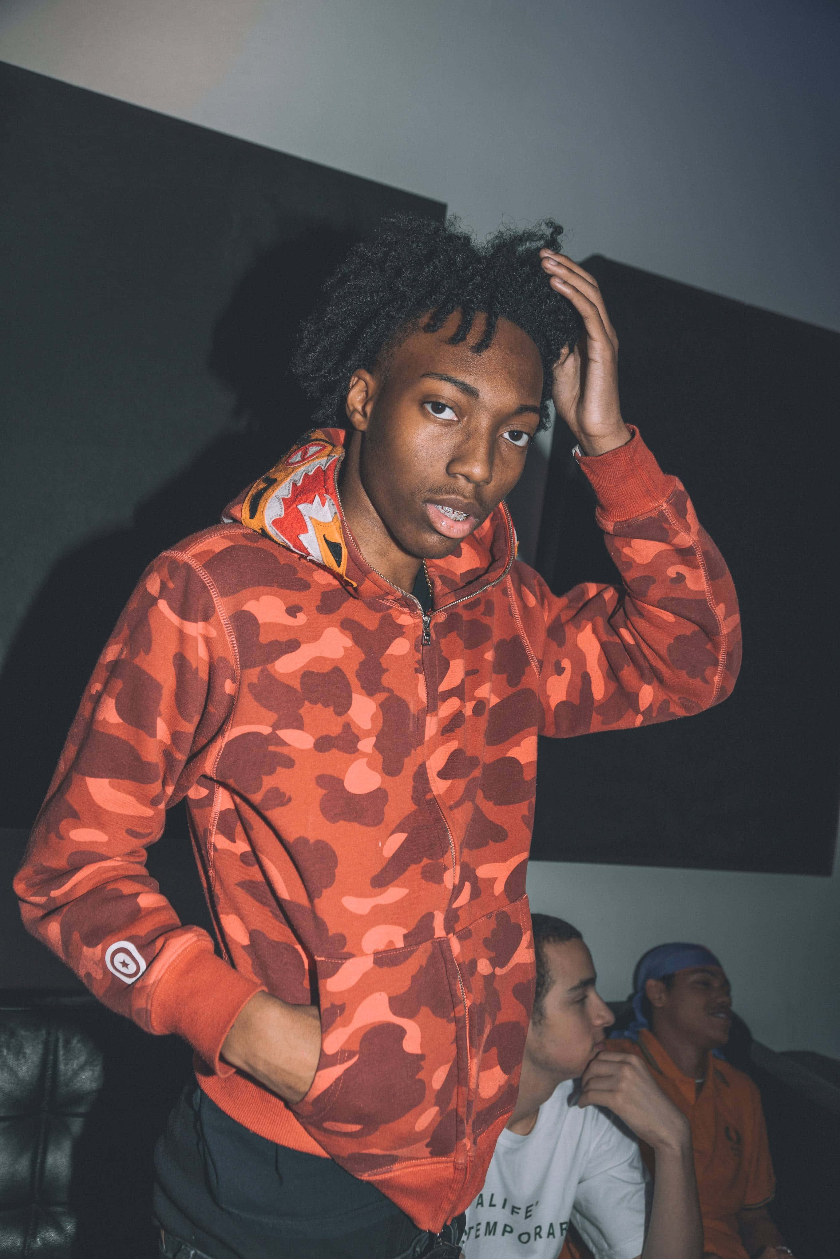 Lil Tecca, orange camouflage hoodie, dramatic lighting, 4K Phone Wallpaper