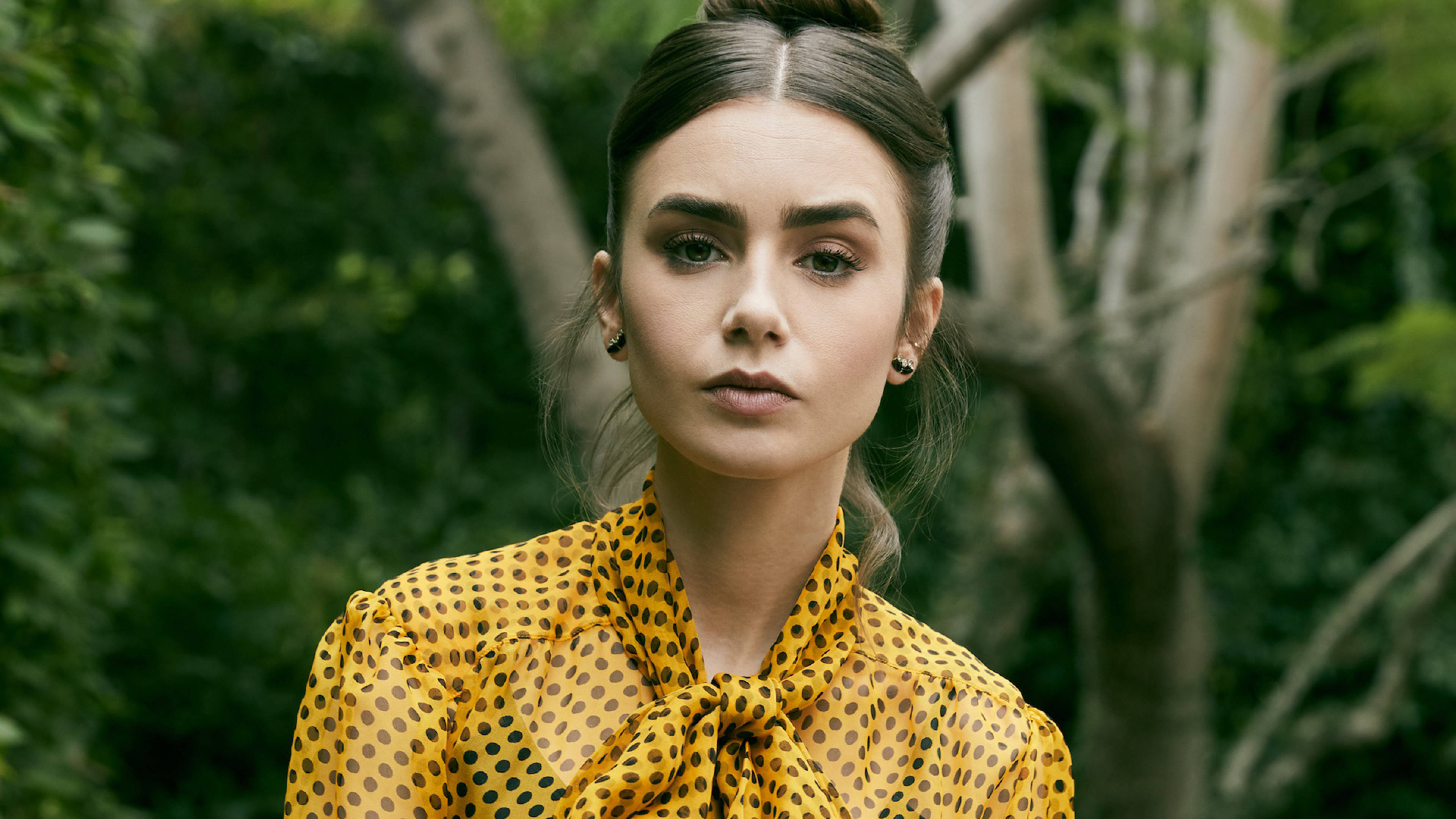 Lily Collins, yellow polka-dot blouse, lush green trees, 4K Desktop Wallpaper