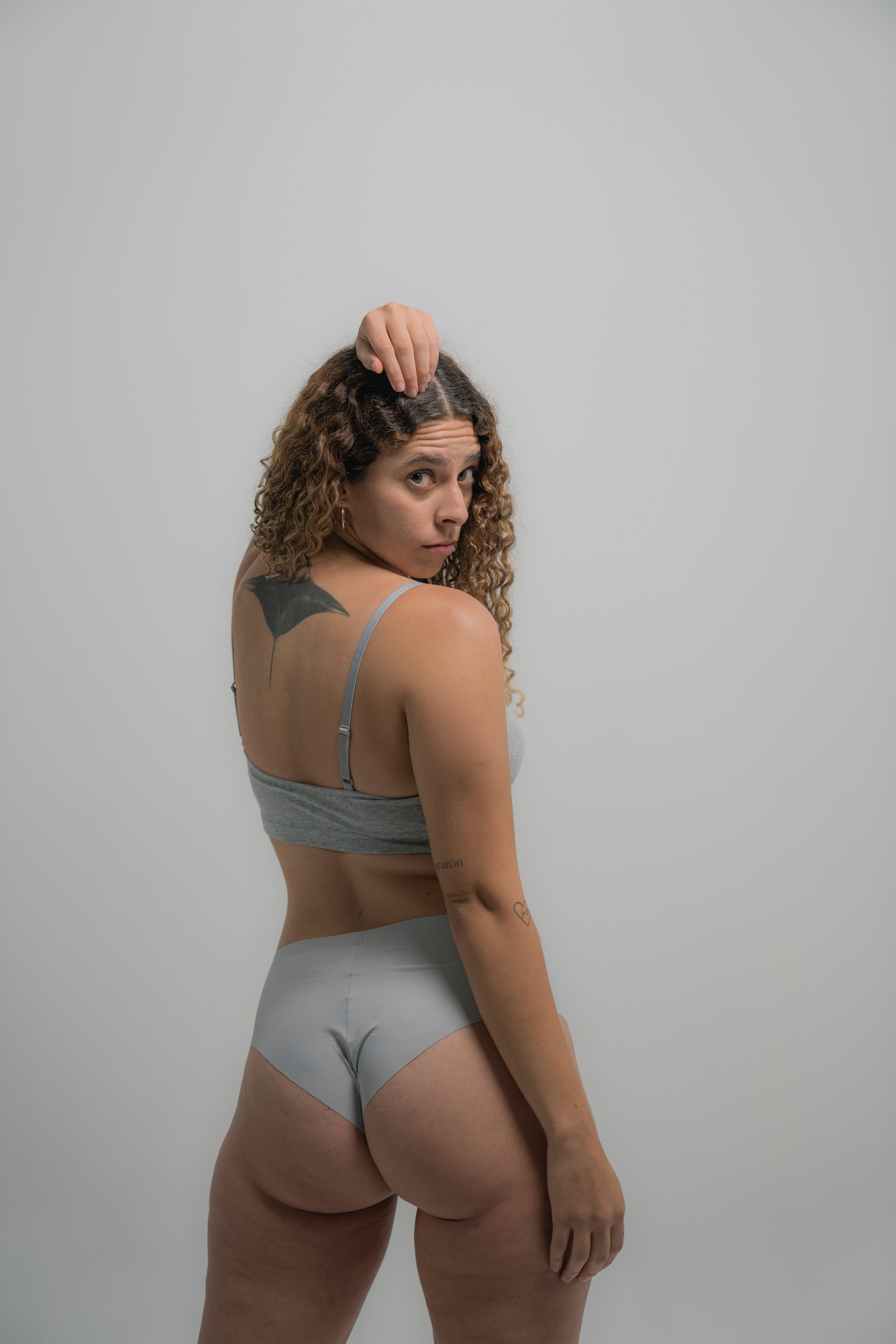 curly hair, bat tattoo on her back, grey underwear, 8K Phone Wallpaper