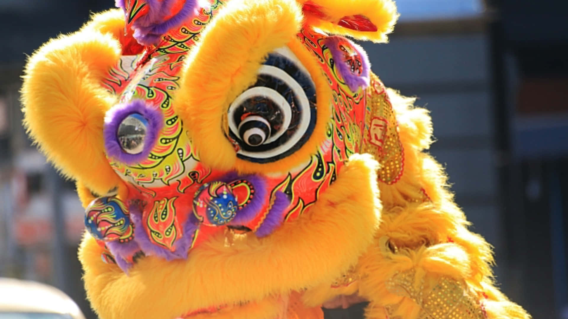 colorful lion dance costume, vibrant yellow, swirling red purple and green patterns, Full HD Desktop Wallpaper