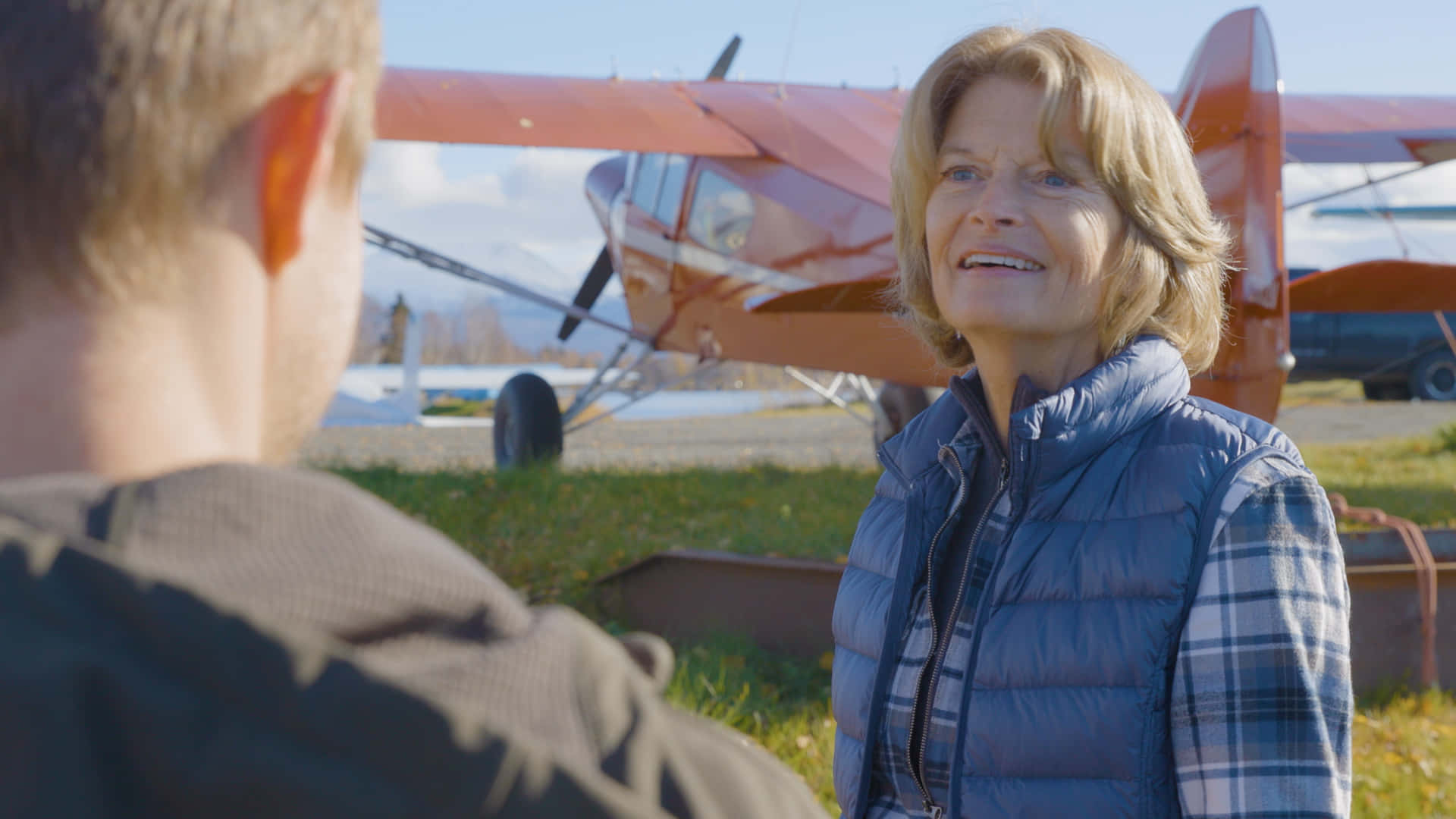 Lisa Murkowski, red floatplane, blue vest, Full HD Desktop Wallpaper