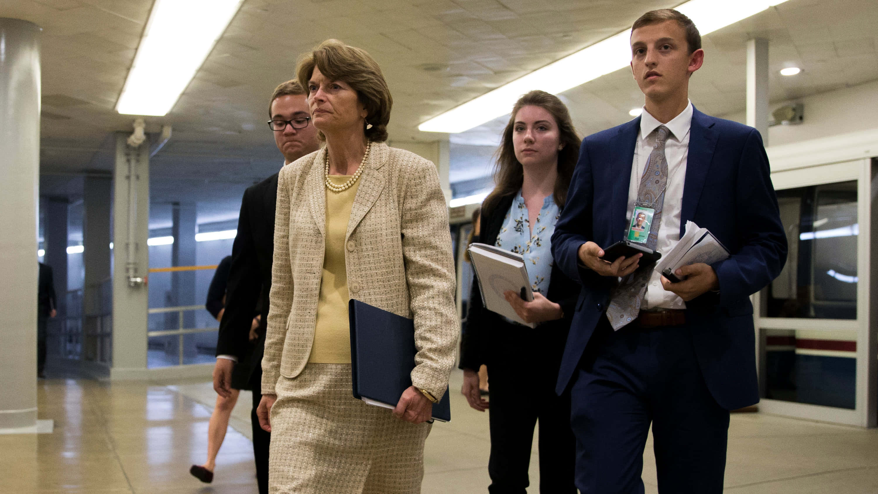 Lisa Murkowski, beige suit, fluorescent-lit hallway, 2K Desktop Wallpaper