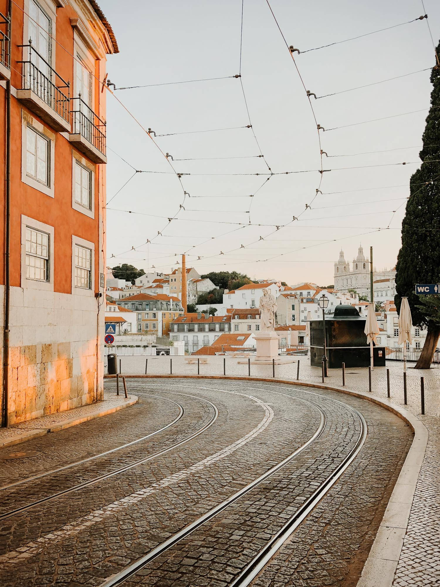 Lisbon, curved cobblestone tram tracks, sunlit Lisbon street, Full HD Phone Wallpaper