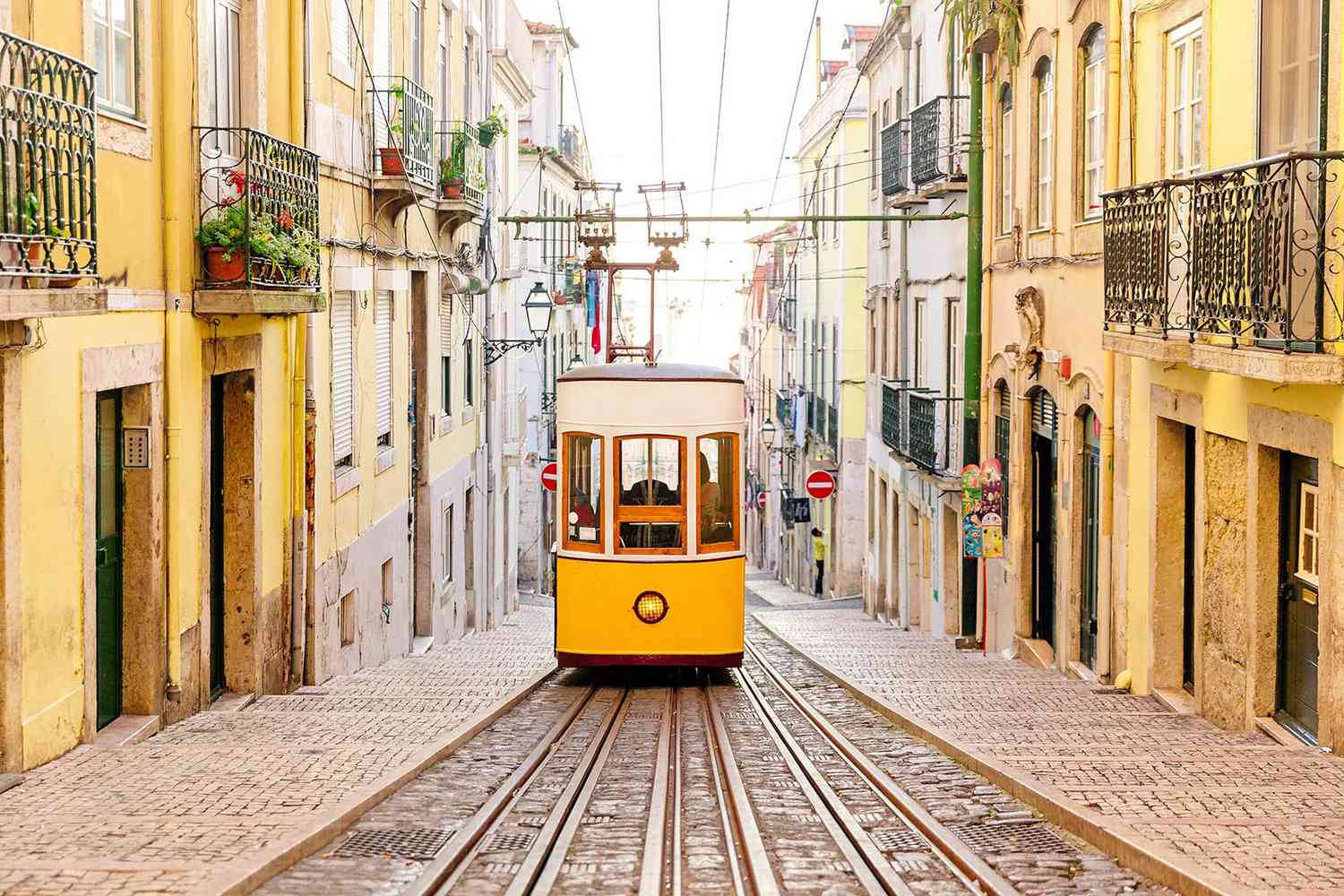 vintage yellow tram, narrow cobblestone street, pastel-colored buildings, HD Desktop Wallpaper