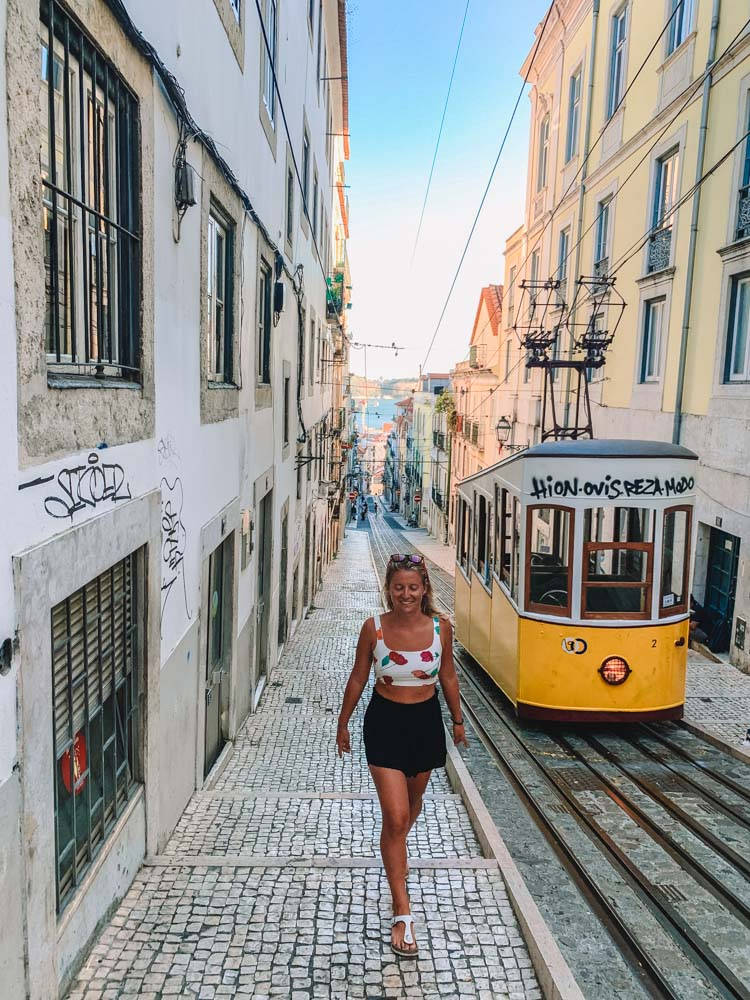 Lisbon, yellow tram, narrow cobblestone street, SD Phone Wallpaper