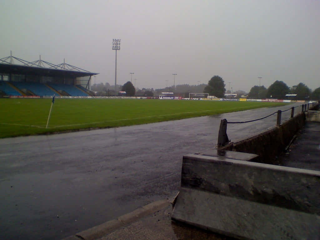 Lisburn United Kingdom, rain-slicked football stadium, empty blue seats, SD Desktop Wallpaper