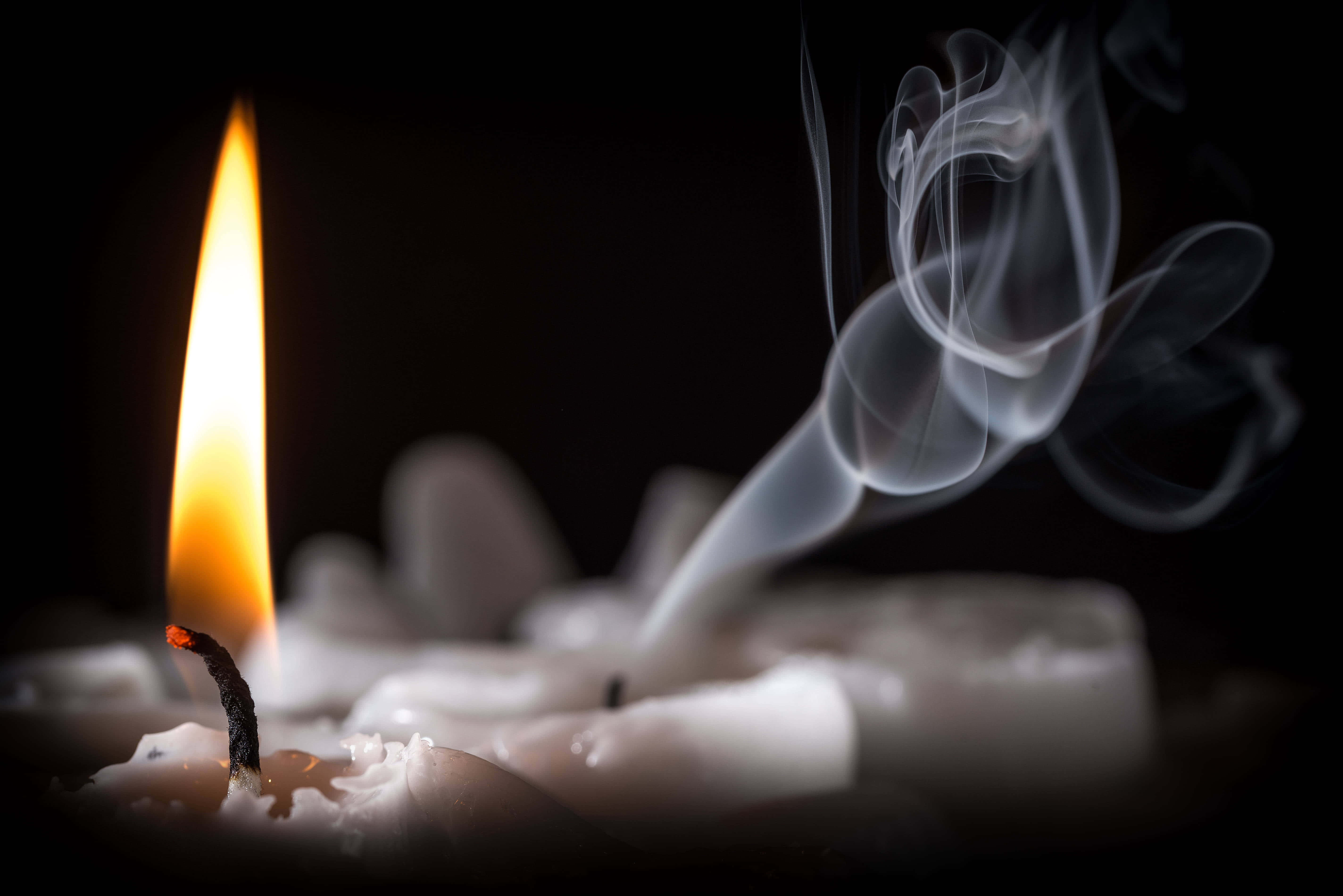 Lit iPhone, candle, black background, 5K Desktop Wallpaper