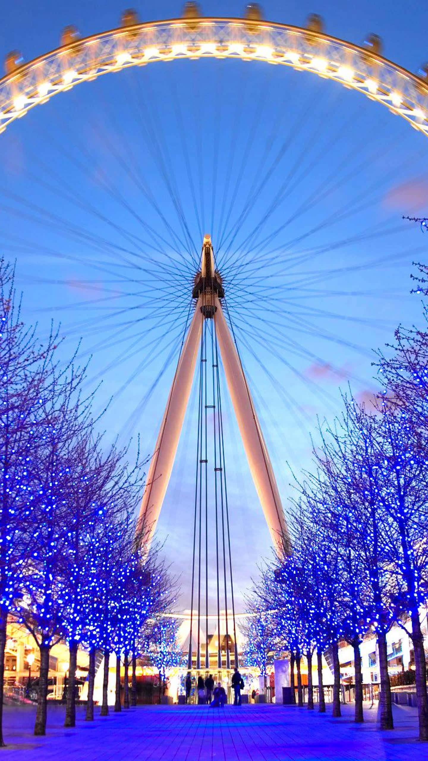 London Eye, twilight urban plaza, blue-lit trees, 2K Phone Wallpaper