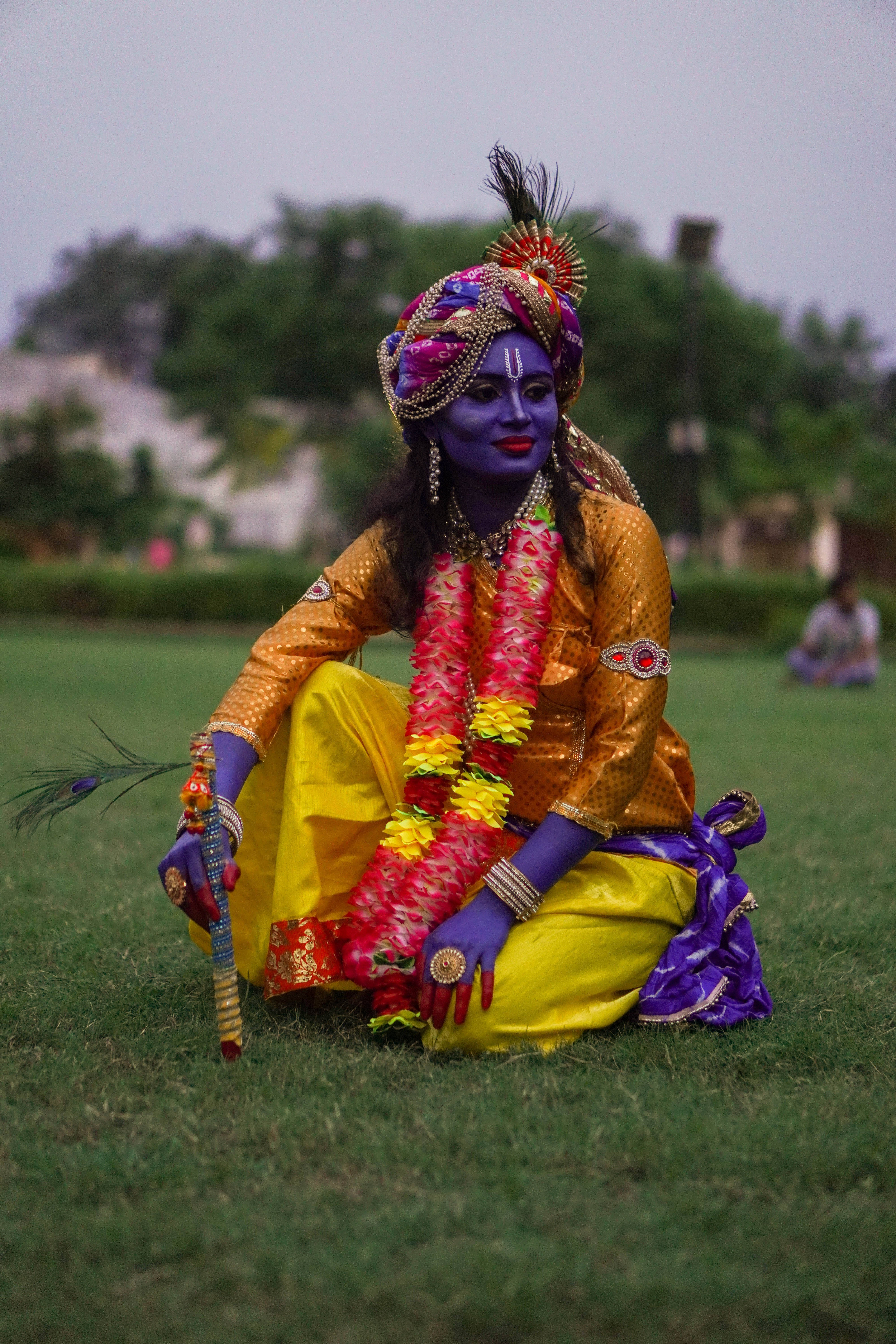 Lord Krishna, blue face paint, vibrant yellow attire, 5K Phone Wallpaper