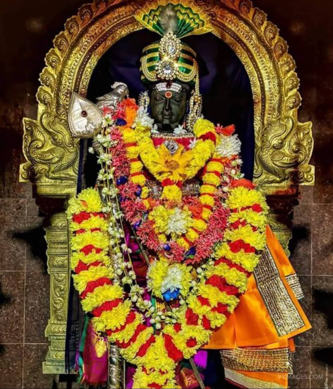 Dark Lord Murugan, dark-skinned deity, vibrant yellow red and white floral garlands, SD Phone Wallpaper