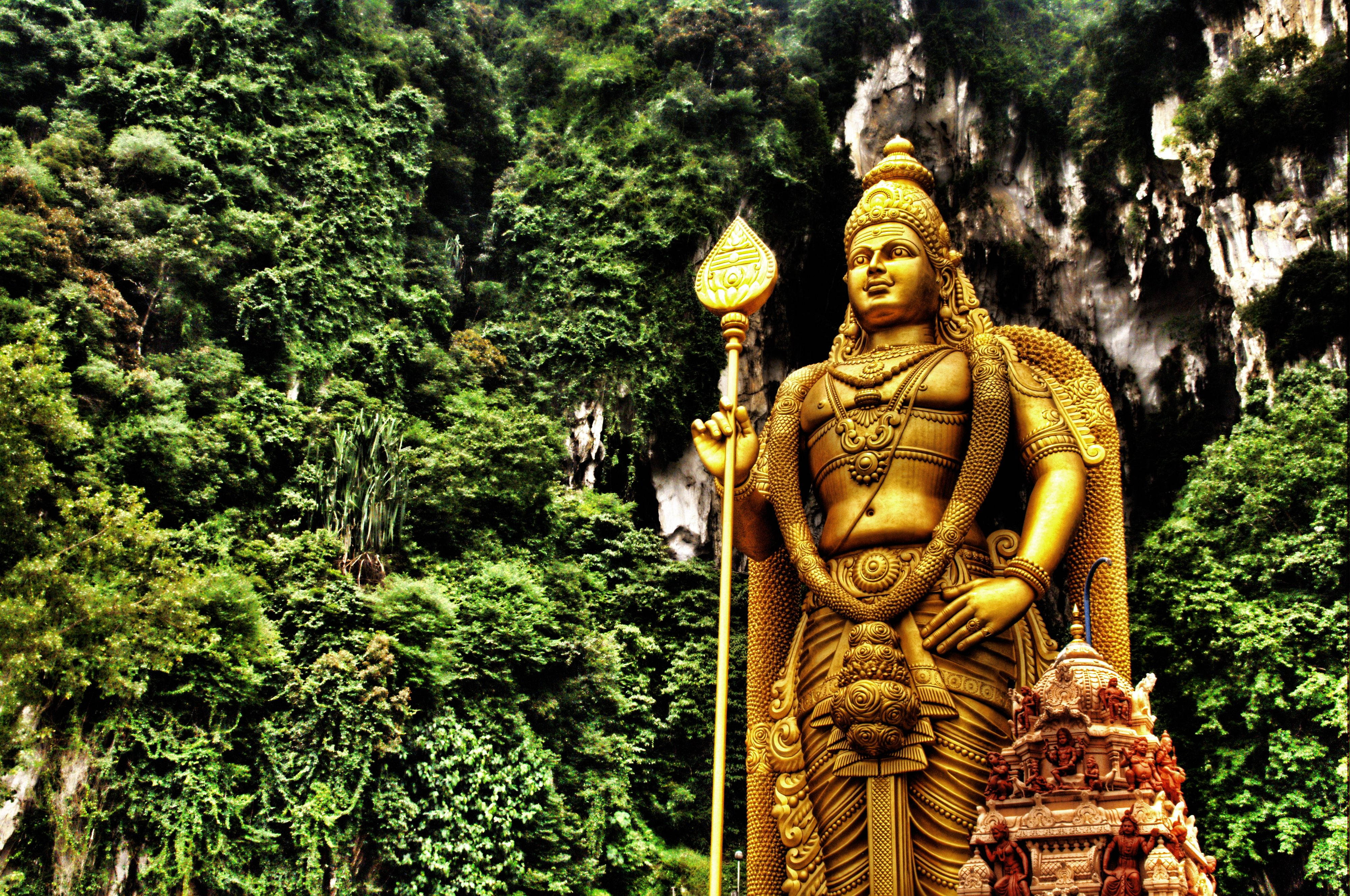 Lord Murugan, golden statue, lush green jungle cliffs, 4K Desktop Wallpaper