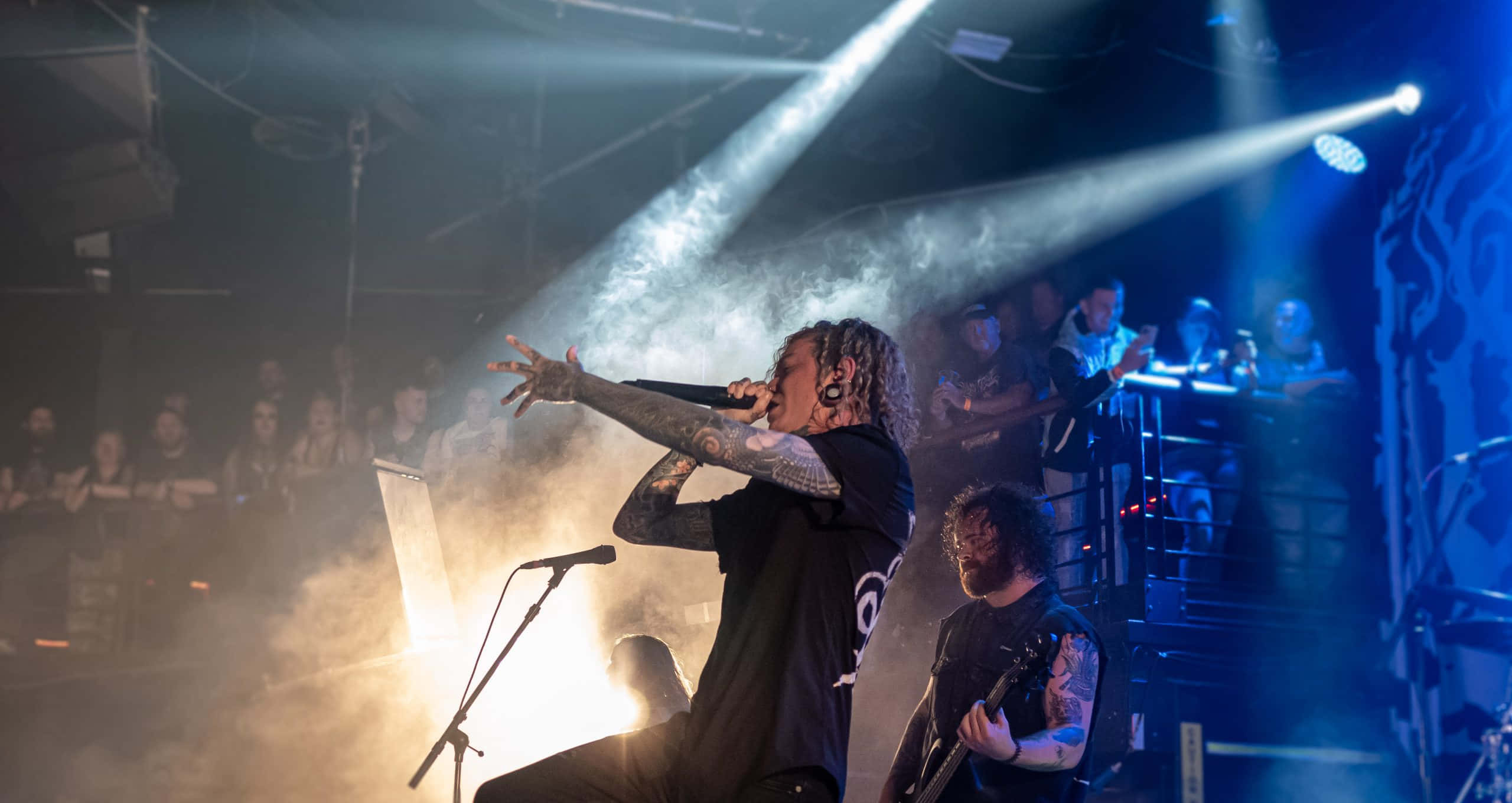 Lorna Shore, live rock stage, bright spotlights, 2K Desktop Wallpaper