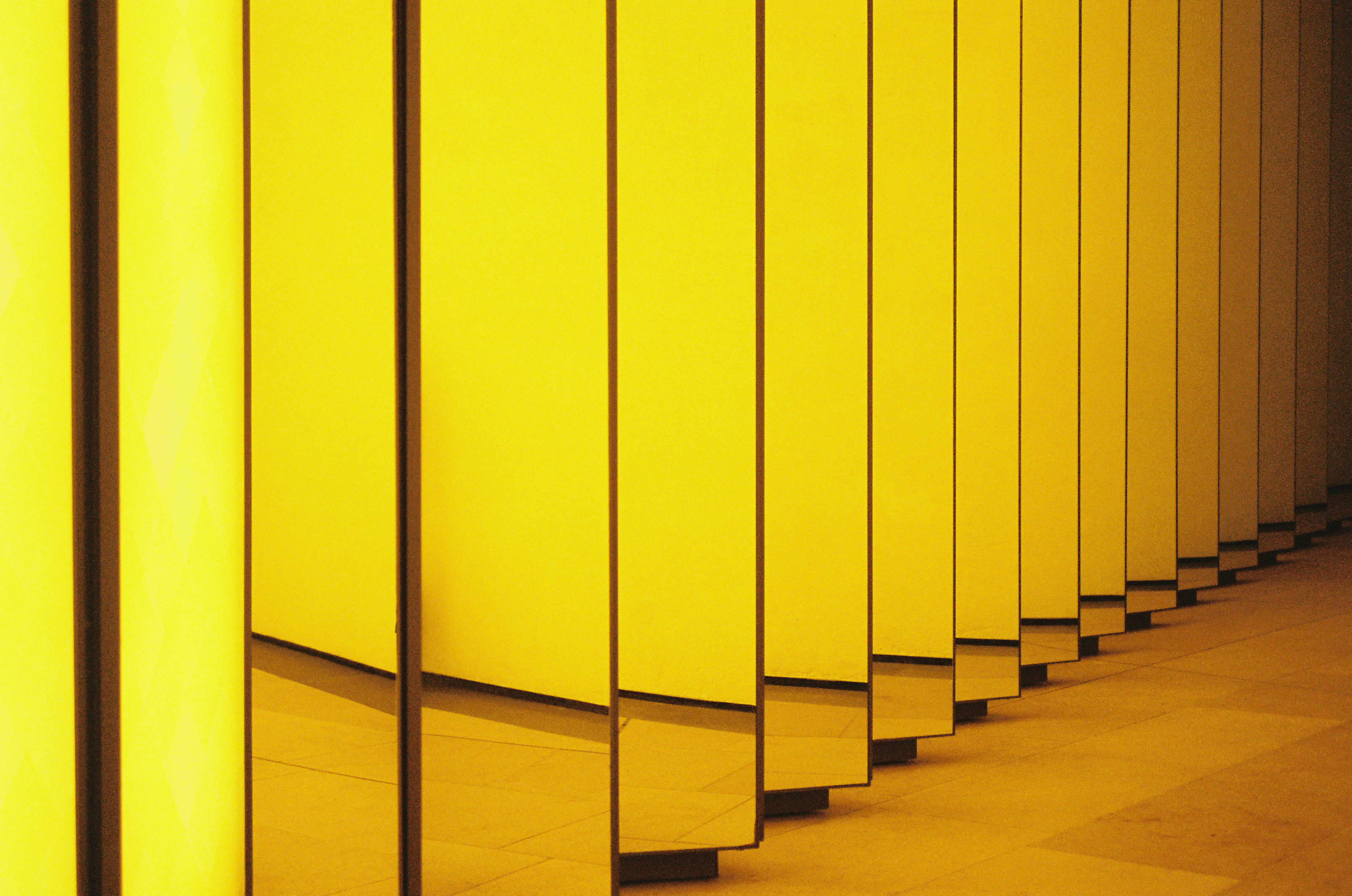 Louis Vuitton, glowing yellow vertical panels, polished floor, 2K Desktop Wallpaper
