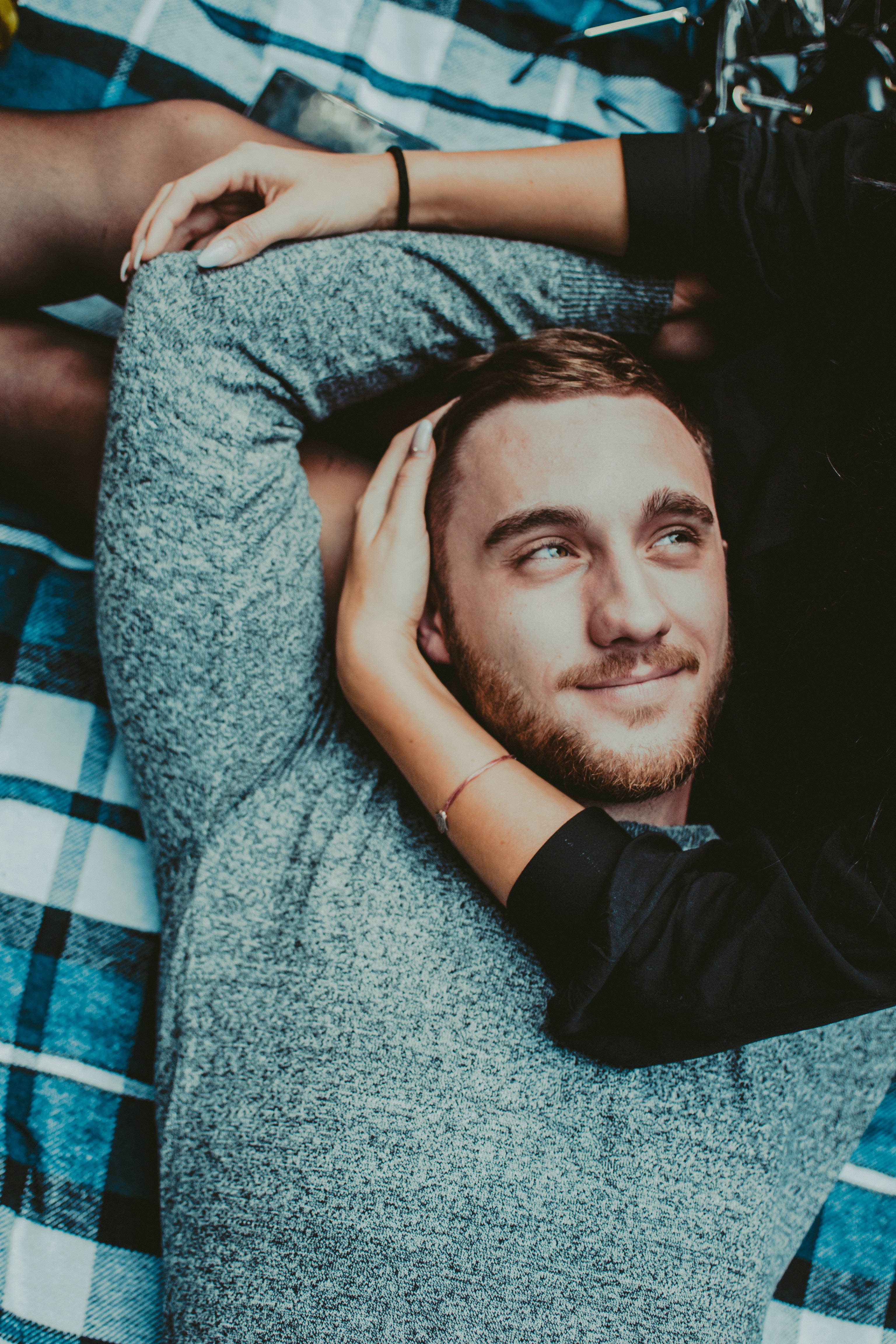 blue plaid blanket, young man with a beard, smiling softly, 4K Phone Wallpaper