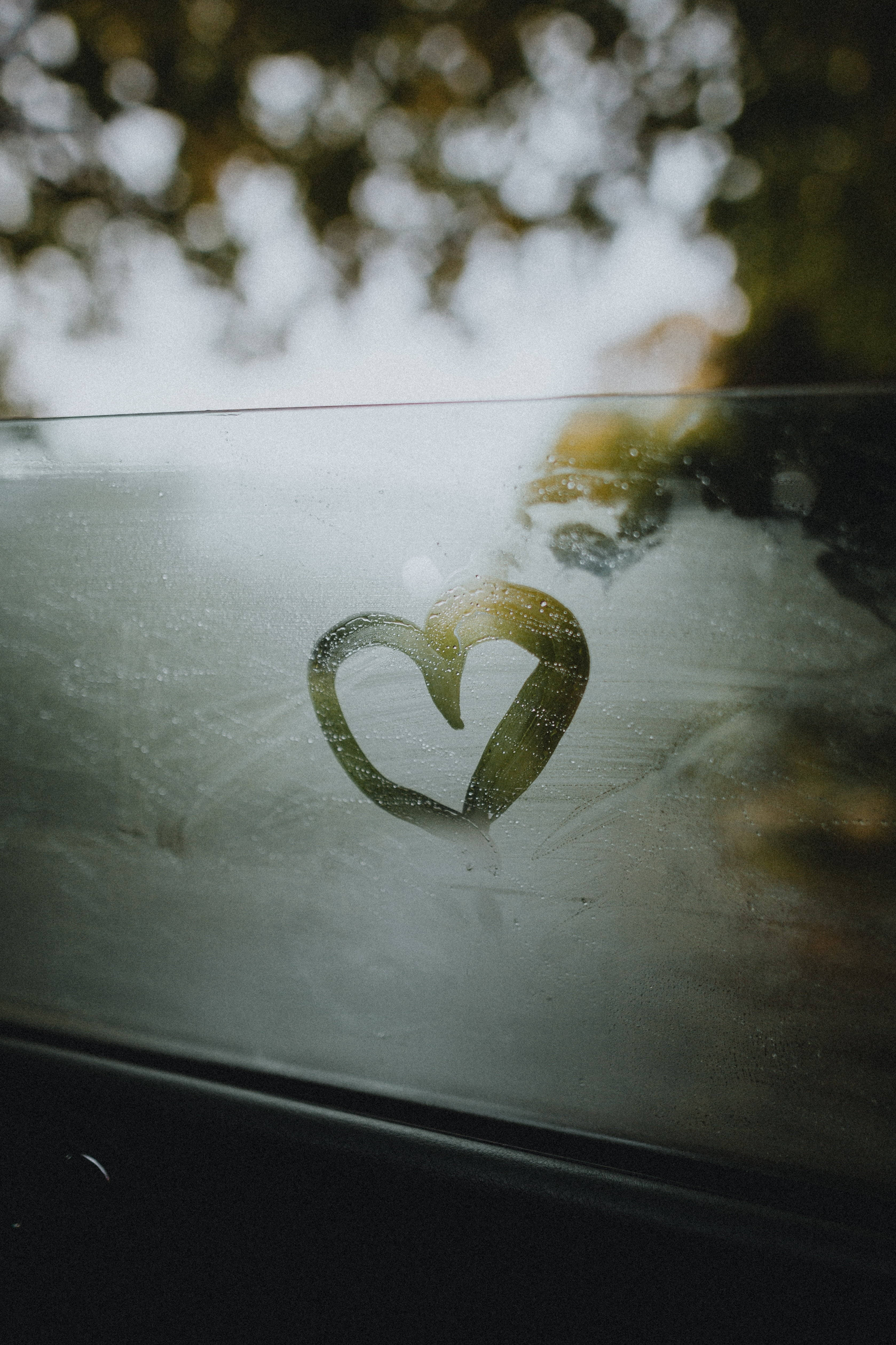 window pane mist, heart-shaped window etching, rain-speckled car window, 4K Phone Wallpaper