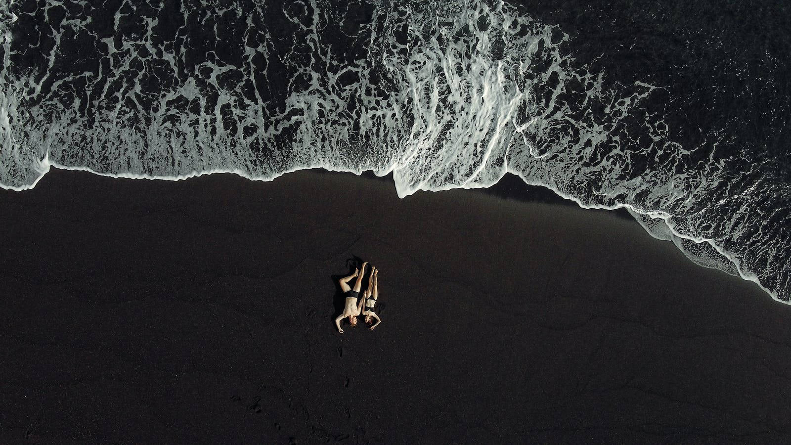 aerial couple shot, black volcanic beach, white foamy waves, HD Desktop Wallpaper