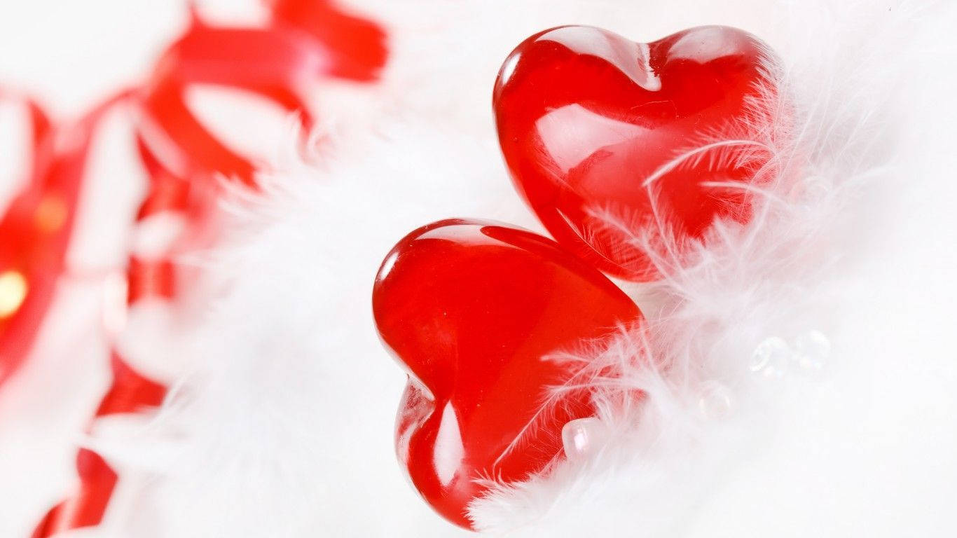 glossy red heart-shaped candies, soft white feathers, blurred red ribbons, HD Desktop Wallpaper