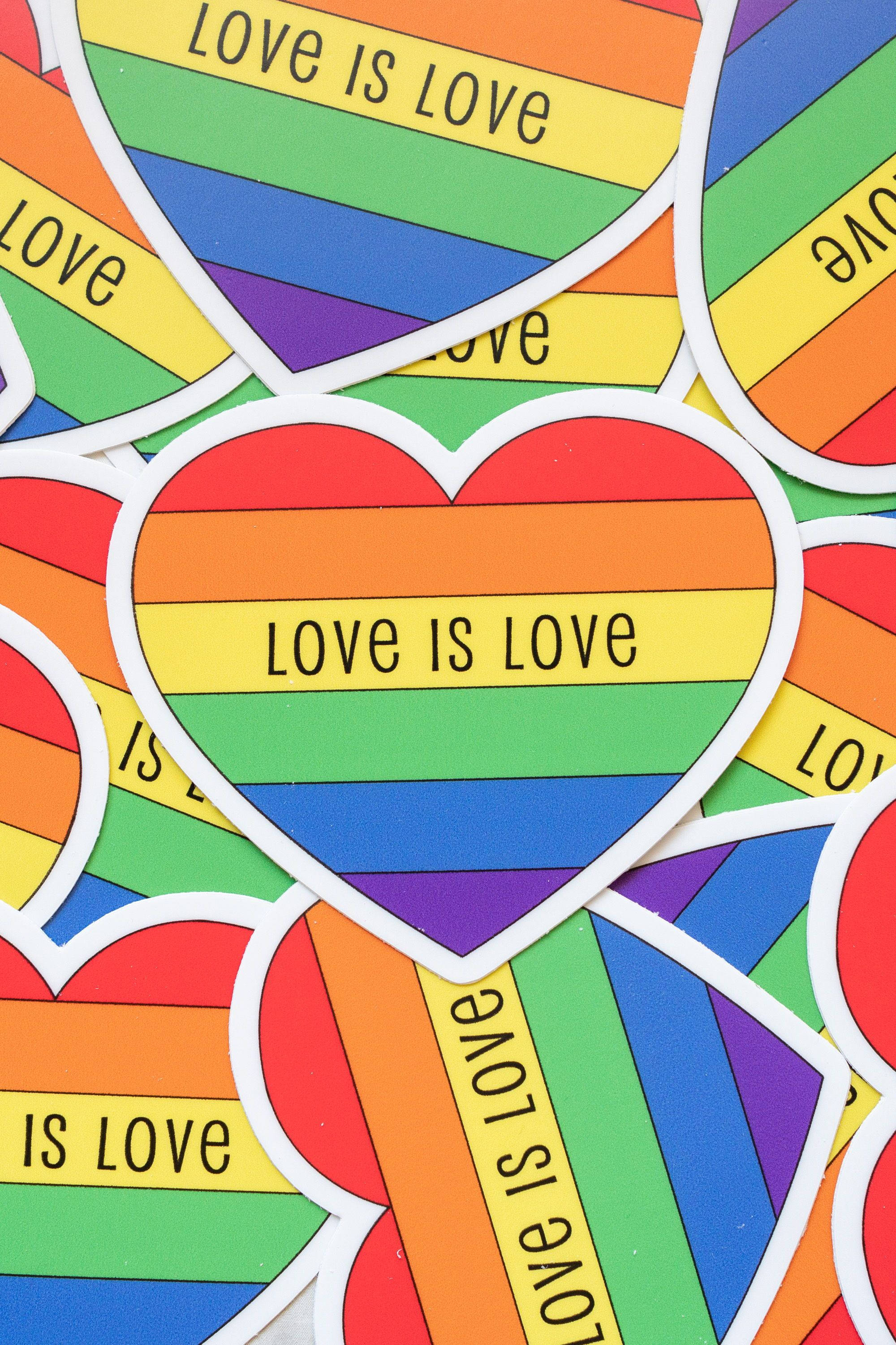 Love Is Love, rainbow heart stickers, bold black letters, 2K Phone Wallpaper