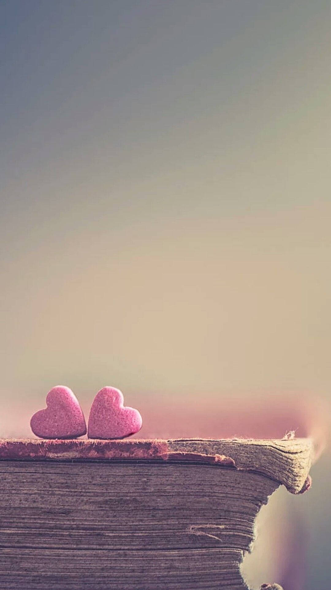 hearts on a book love phone, pink heart-shaped stones, weathered book, Full HD Phone Wallpaper