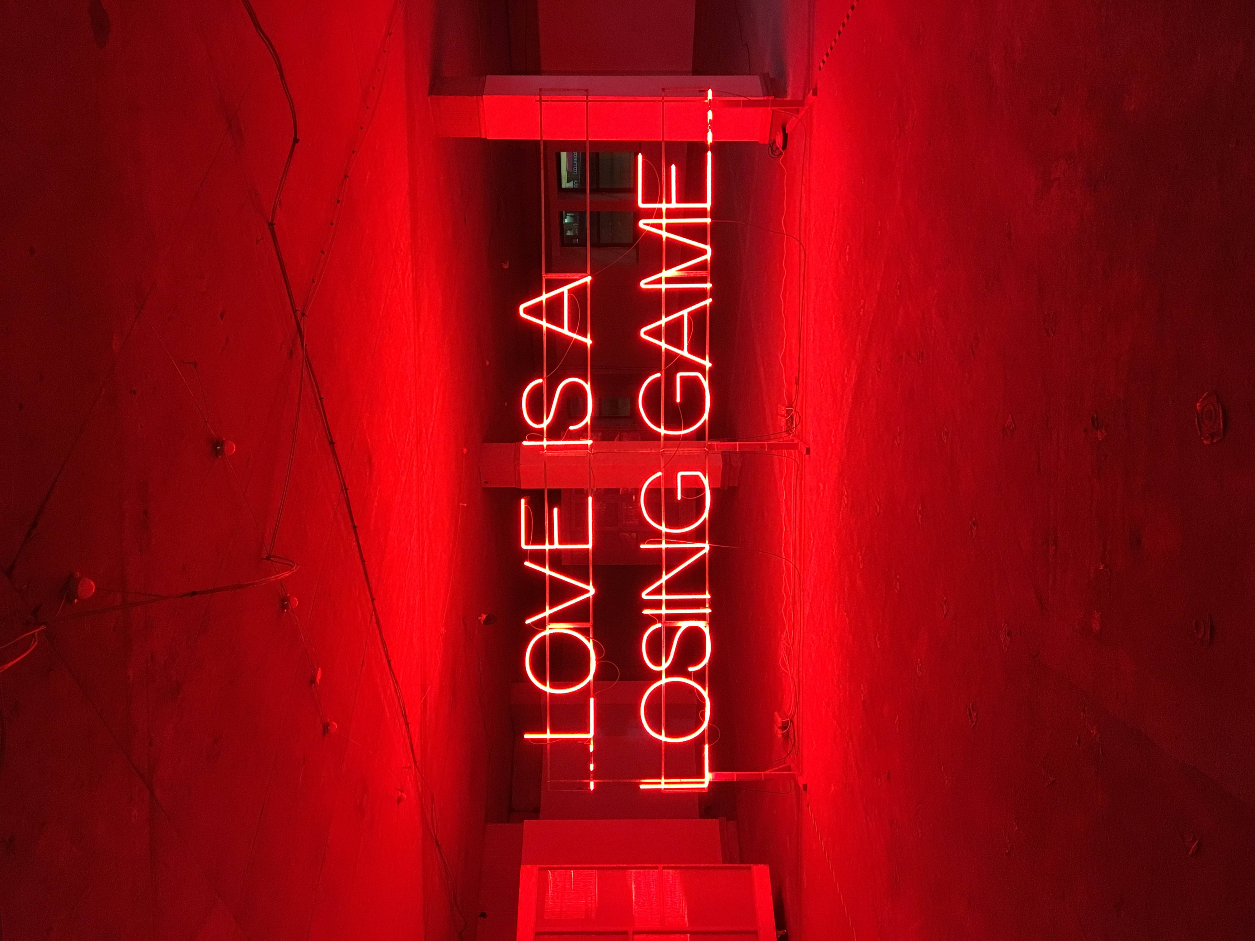red neon sign, LOVE IS A LOSING GAME, textured concrete walls, 4K Desktop Wallpaper