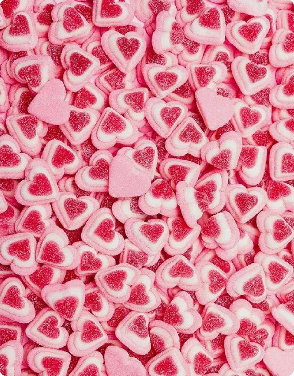 pink heart-shaped candies, sugary texture, red centers, SD Phone Wallpaper