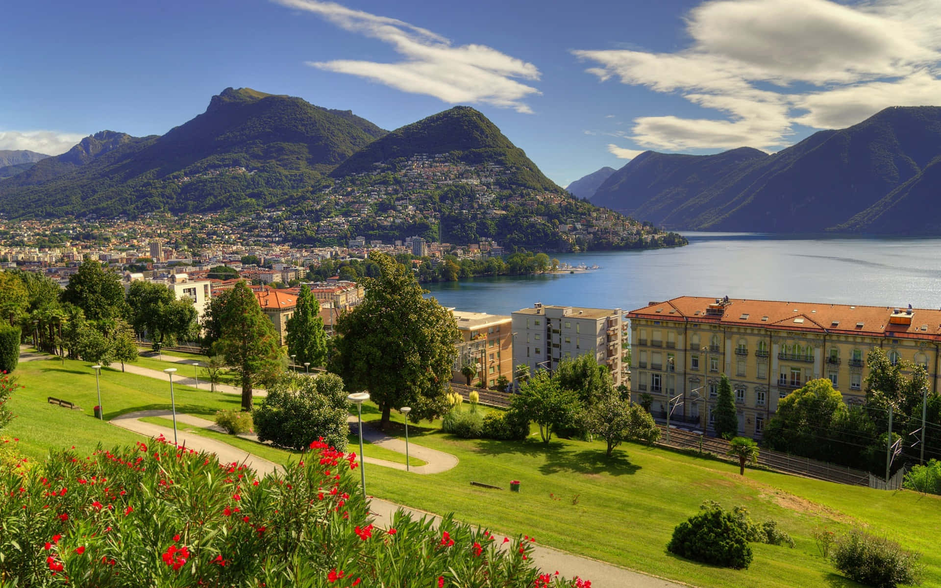 Lugano Lake, lush green mountains, bright blue sky, Full HD Desktop Wallpaper