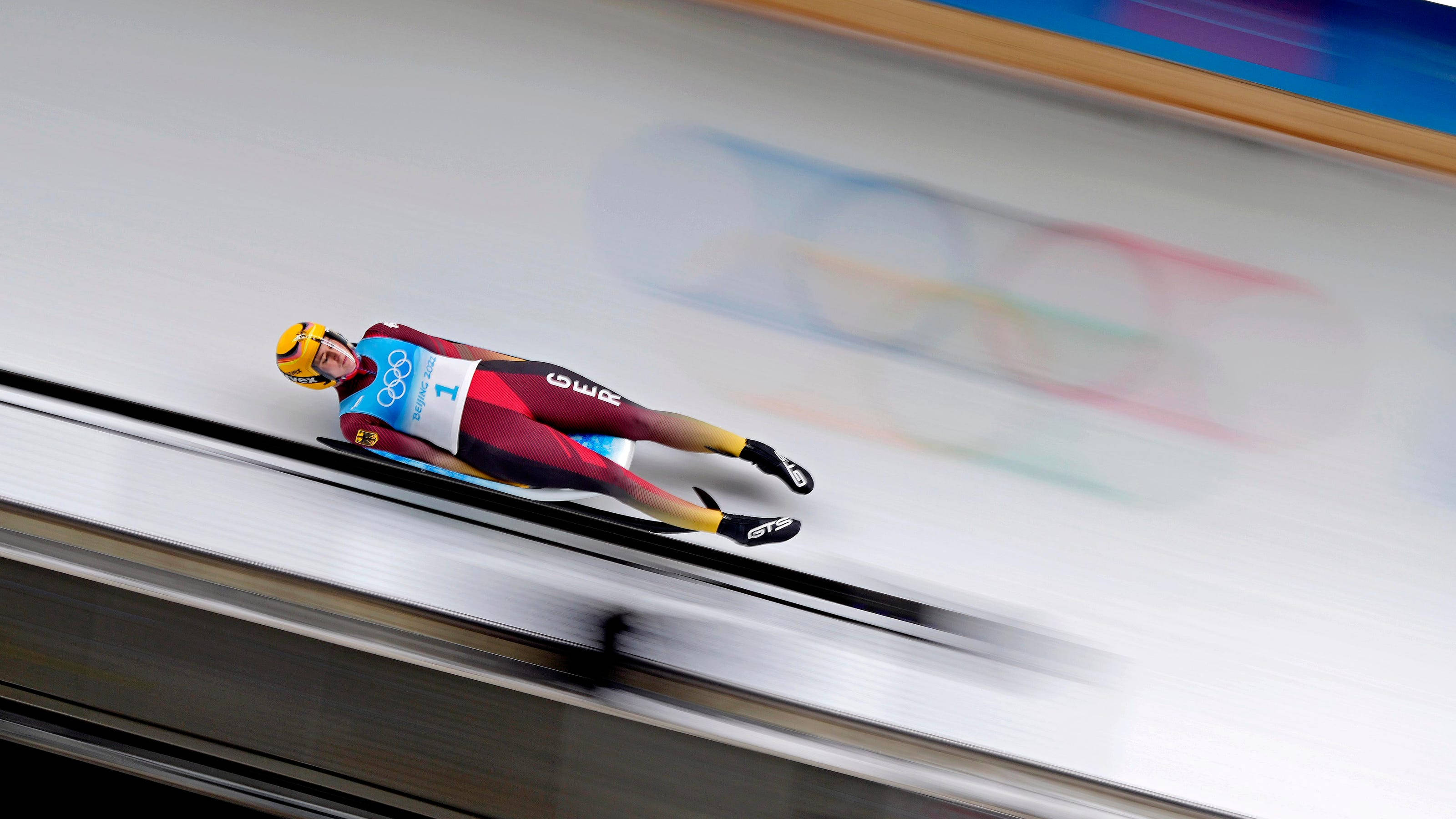 luge athlete, maroon and blue suit, icy track, 2K Desktop Wallpaper