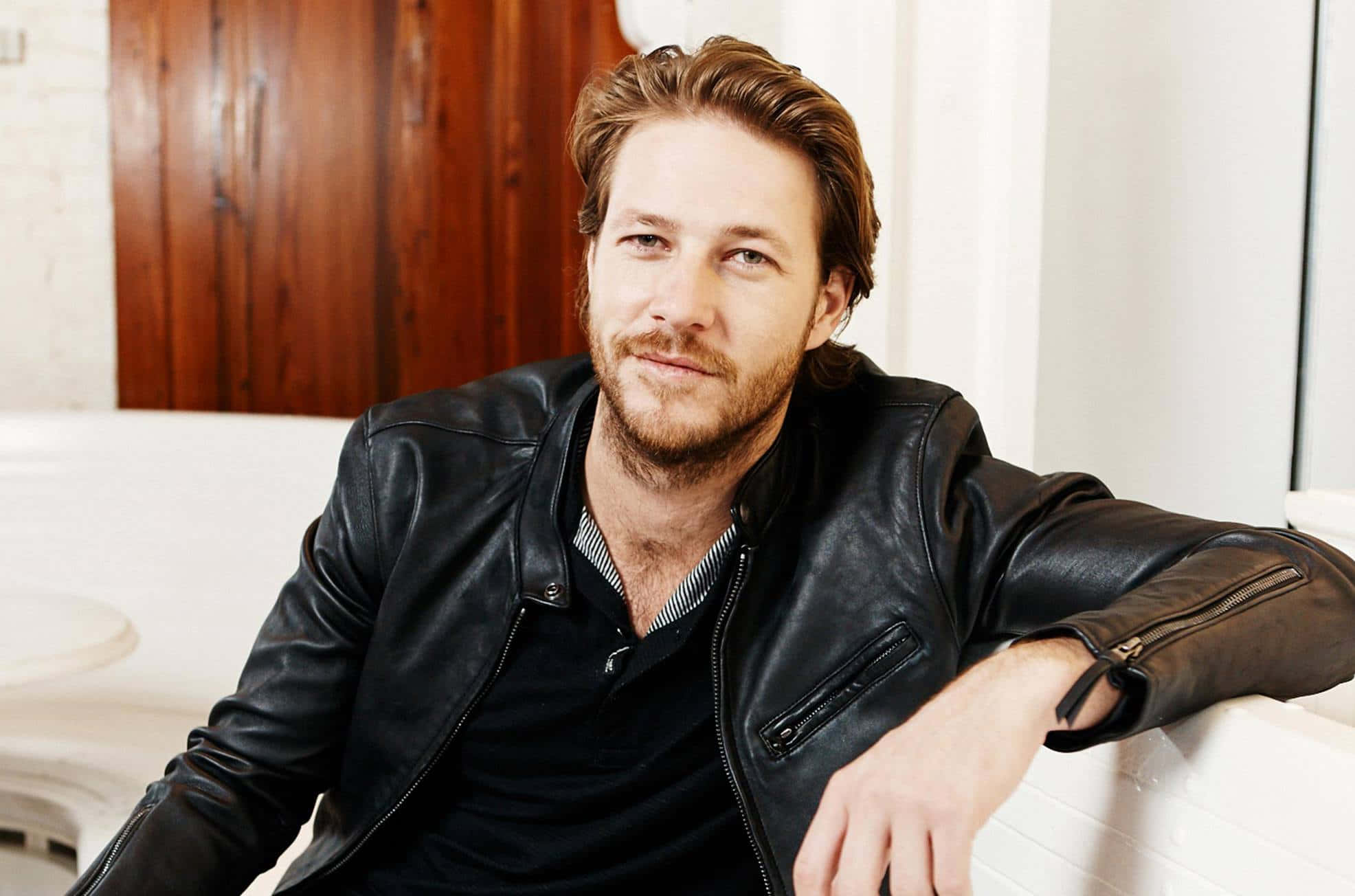 Luke Bracey, black leather jacket, white couch, Full HD Desktop Wallpaper