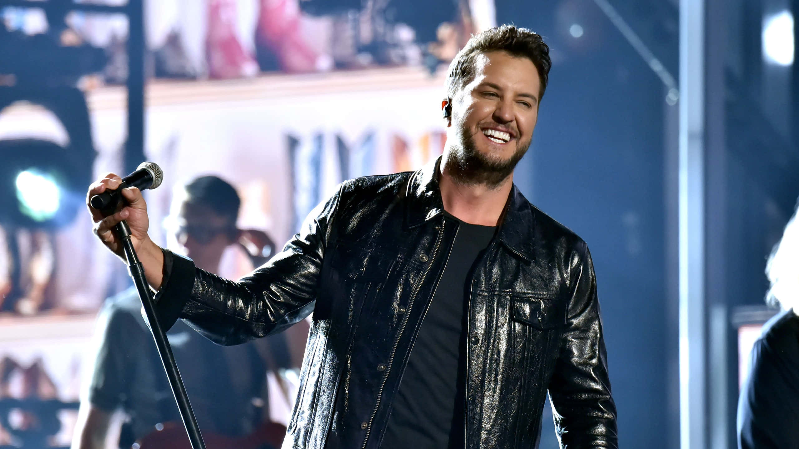 Luke Bryan, black leather jacket, brightly lit stage, 2K Desktop Wallpaper