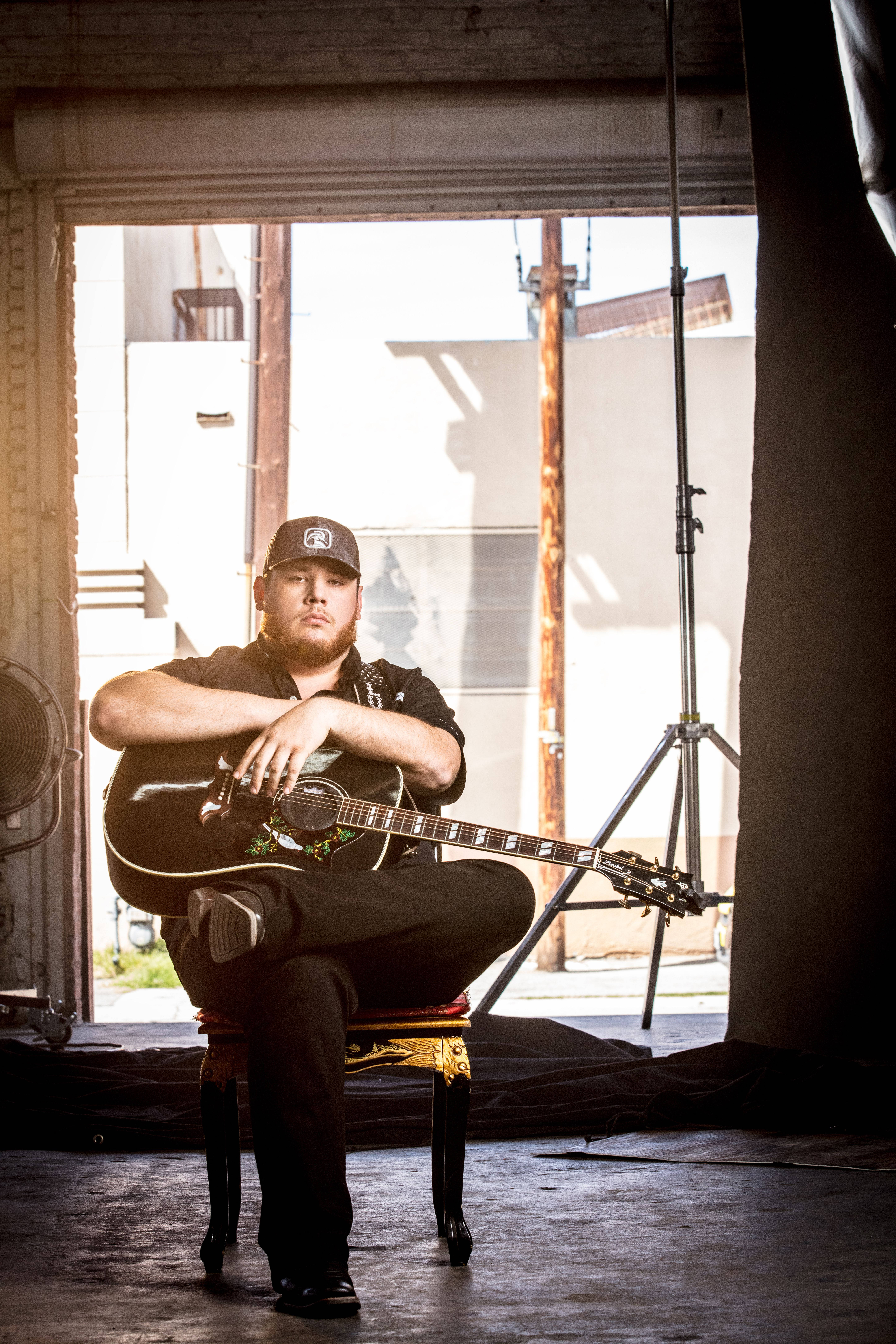 Luke Combs, acoustic guitar, sunlit industrial studio space, 8K Phone Wallpaper