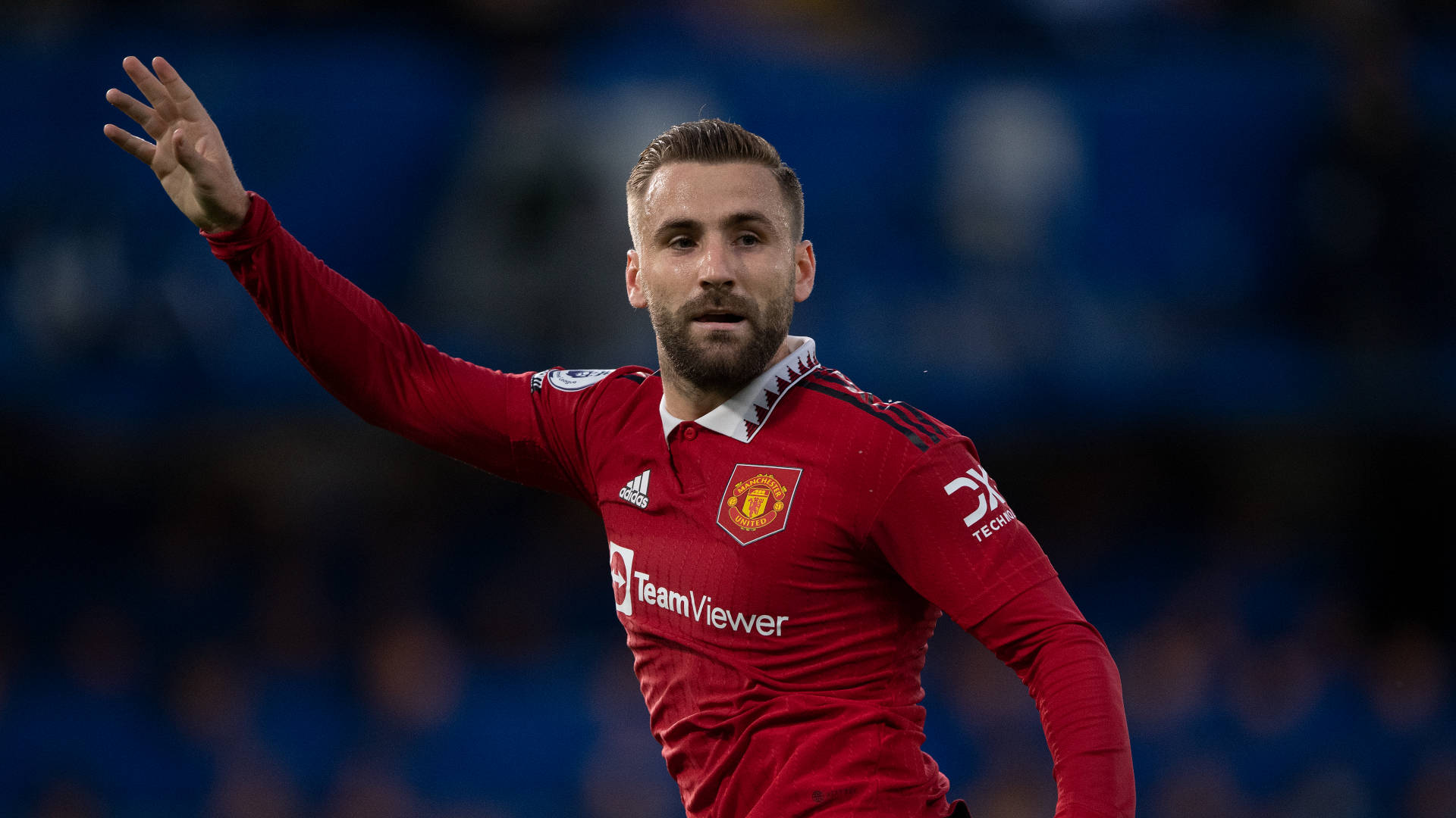 Luke Shaw, red Manchester United jersey, blue stadium background, Full HD Desktop Wallpaper
