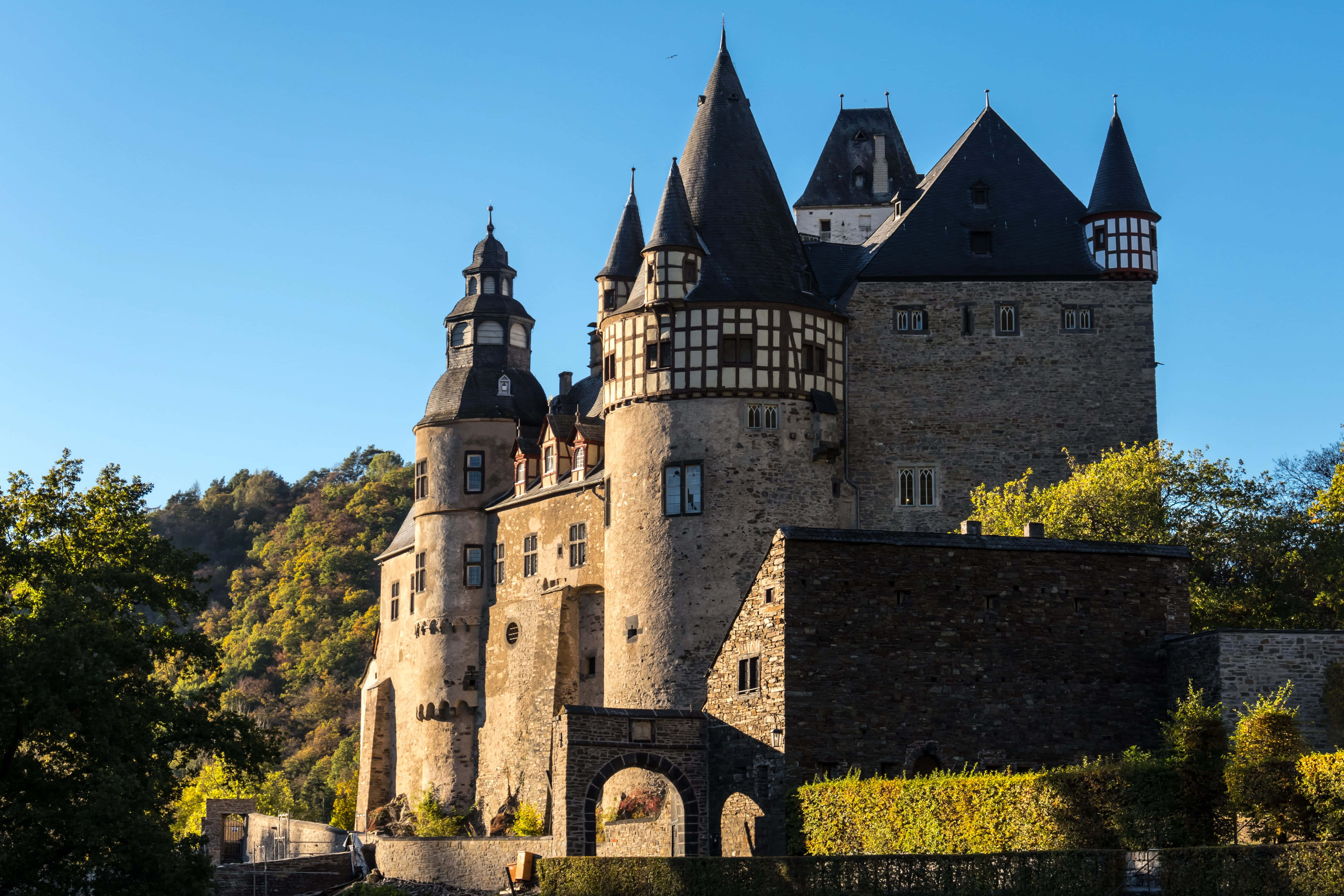 luxury castle investment, stone castle, dark conical roofs, 5K Desktop Wallpaper