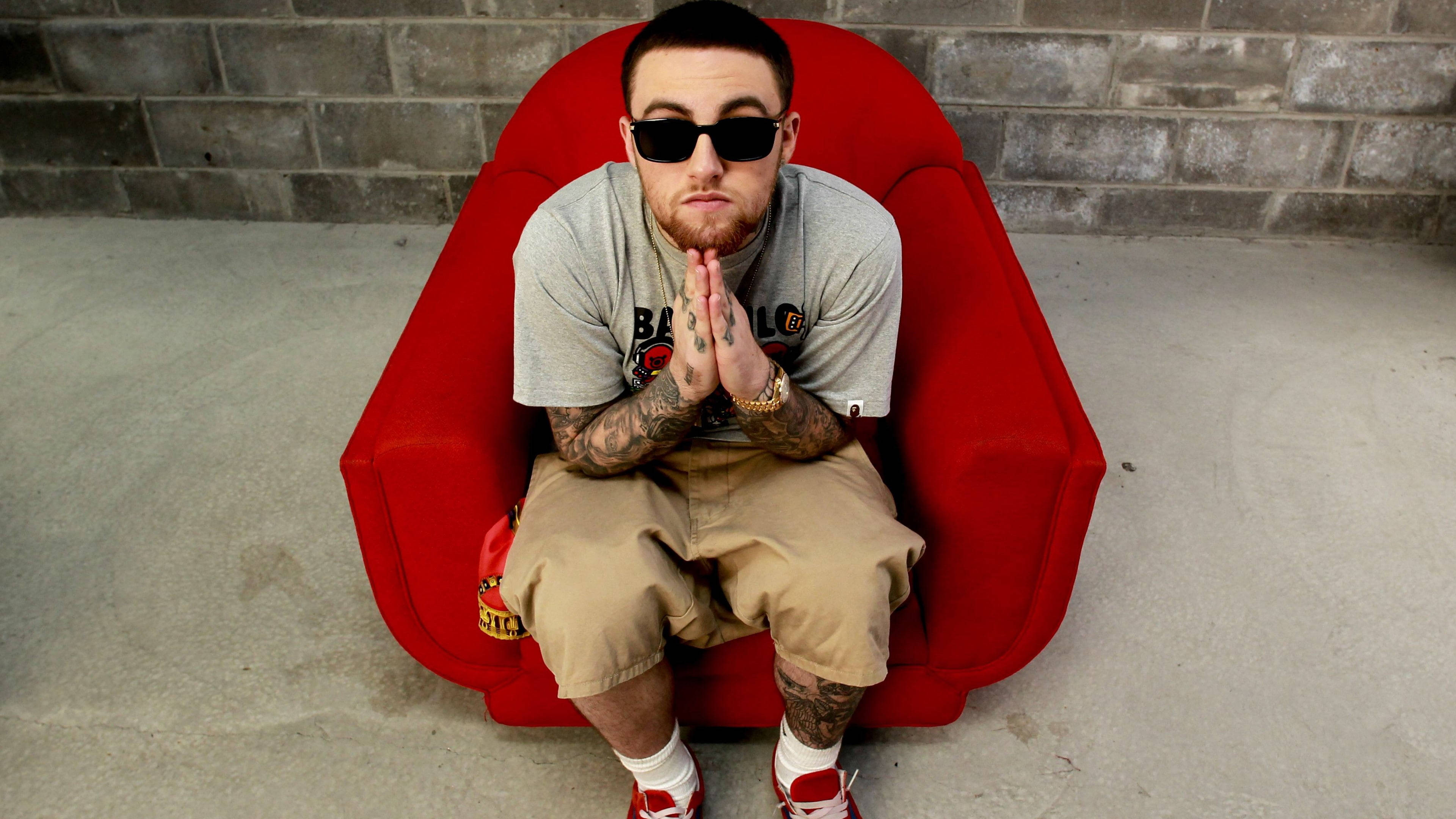 Mac Miller, red chair, gray brick wall, 4K Desktop Wallpaper