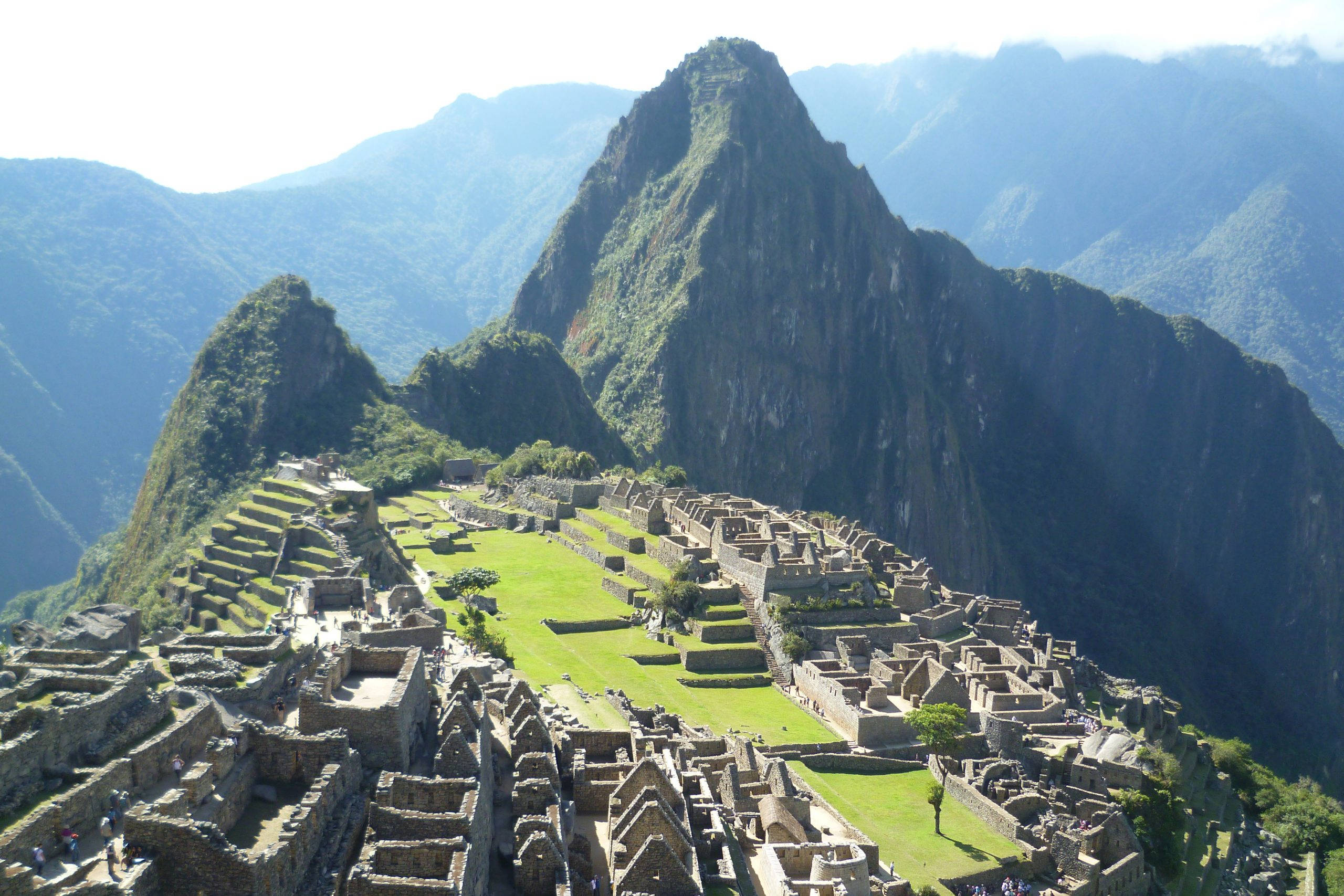 Machu Picchu, sunlit mountain ridge, ancient stone ruins, 2K Desktop Wallpaper