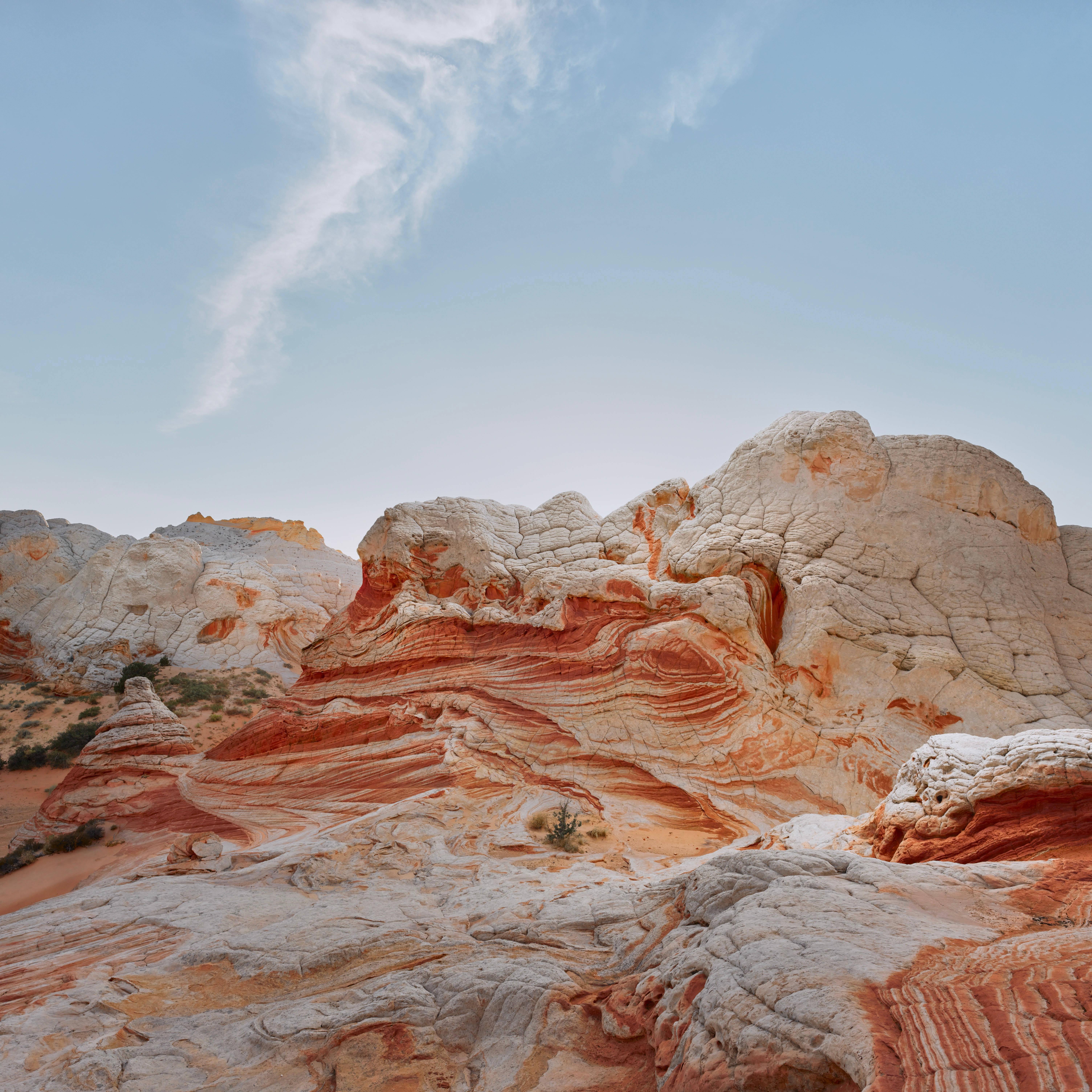 macOS Big Sur, red and white rock formations, pale blue sky, 5K Desktop Wallpaper
