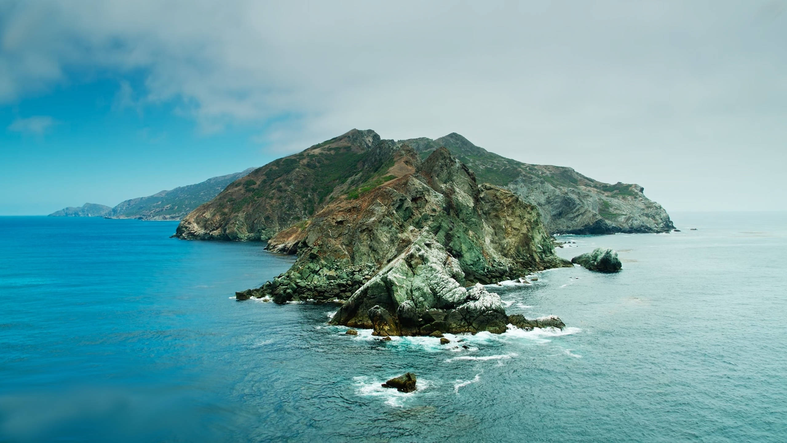 macOS Catalina, rocky mountain, turquoise waters, 2K Desktop Wallpaper
