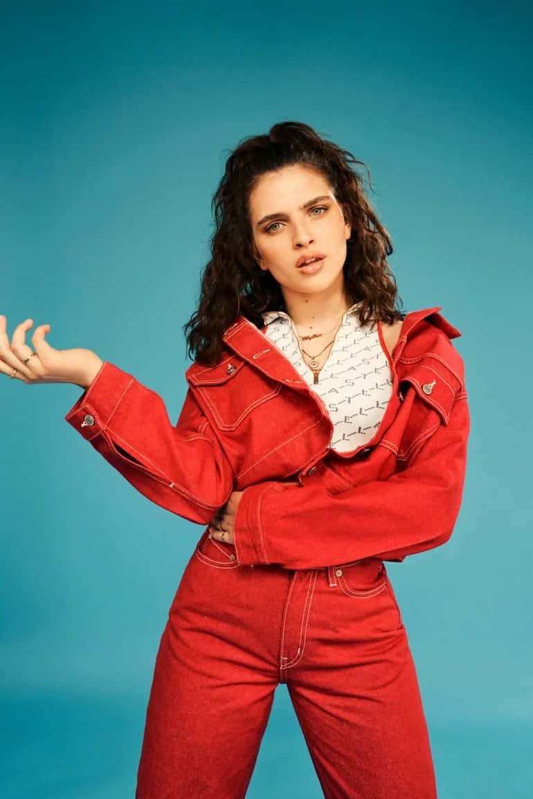 Mae Muller, bold red denim outfit, solid teal studio background, SD Phone Wallpaper
