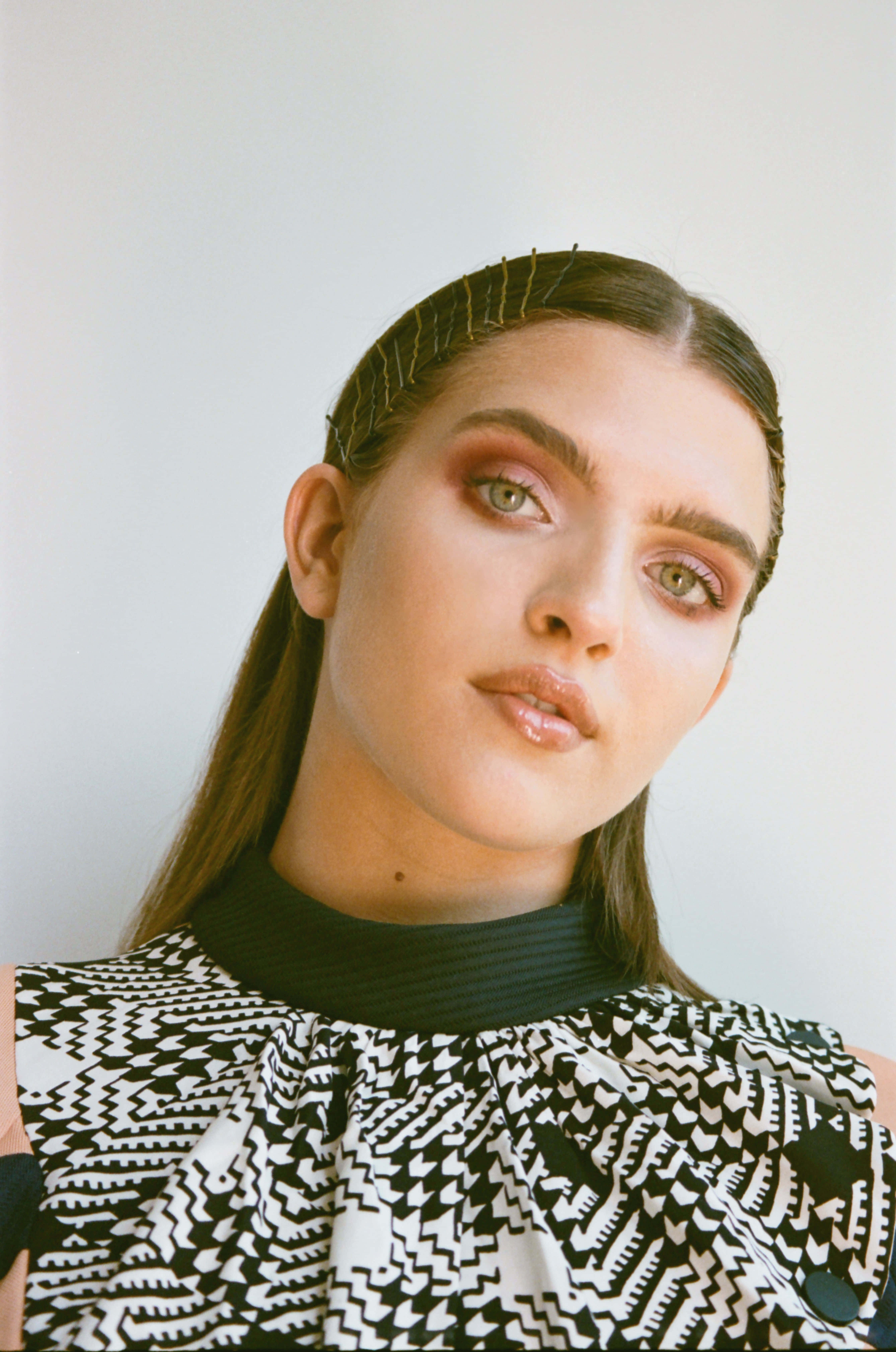Mae Muller, black and white geometric patterned top, striking green eyes, 5K Phone Wallpaper