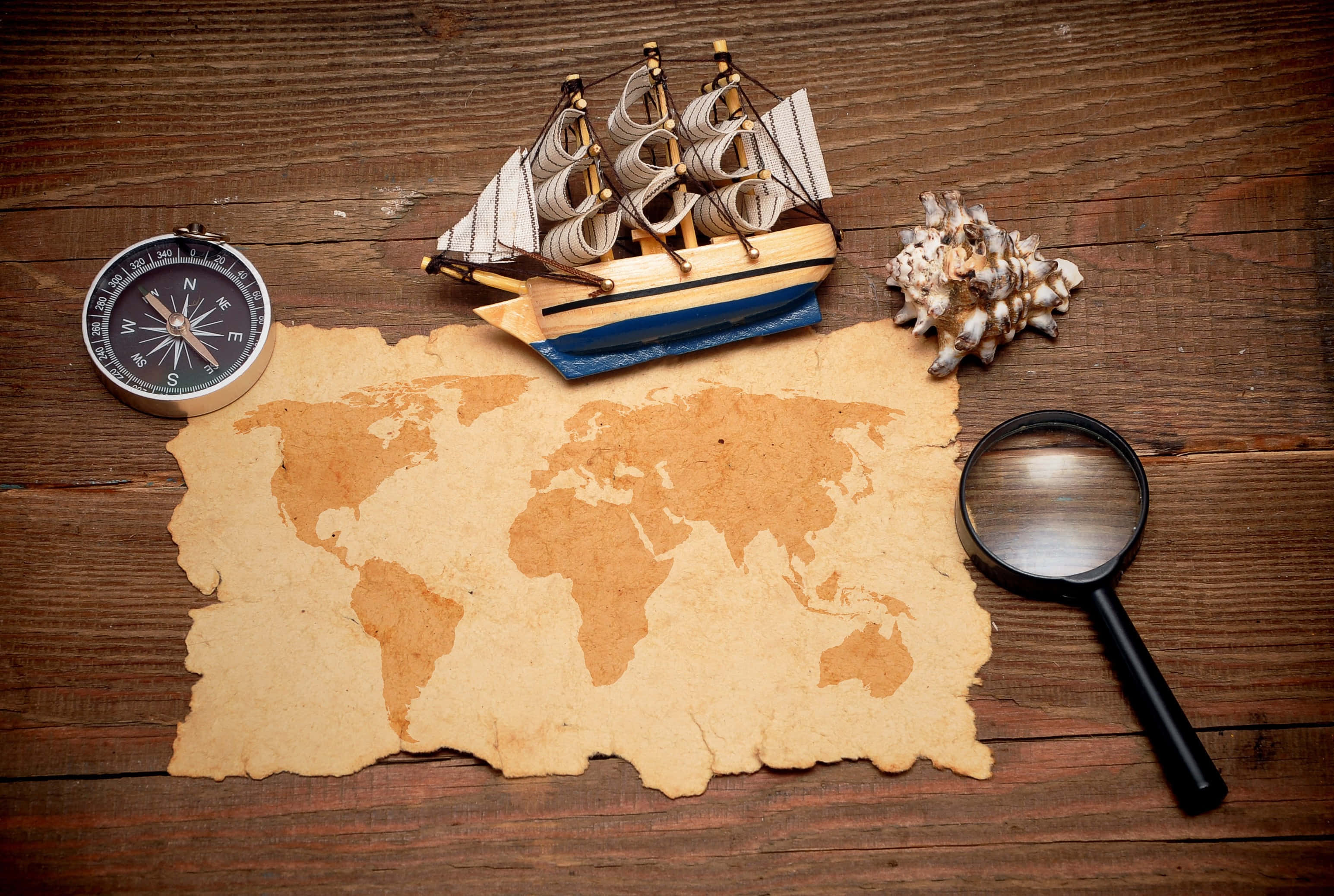 vintage world map, wooden table, model ship compass, 2K Desktop Wallpaper
