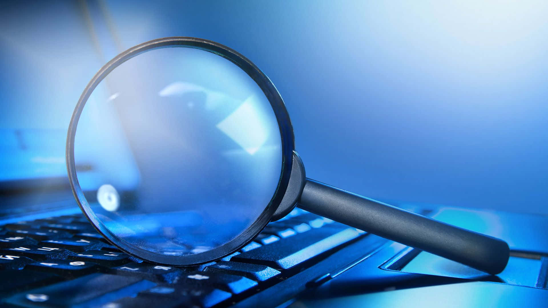 magnifying glass, laptop keyboard, cool blue lighting, Full HD Desktop Wallpaper