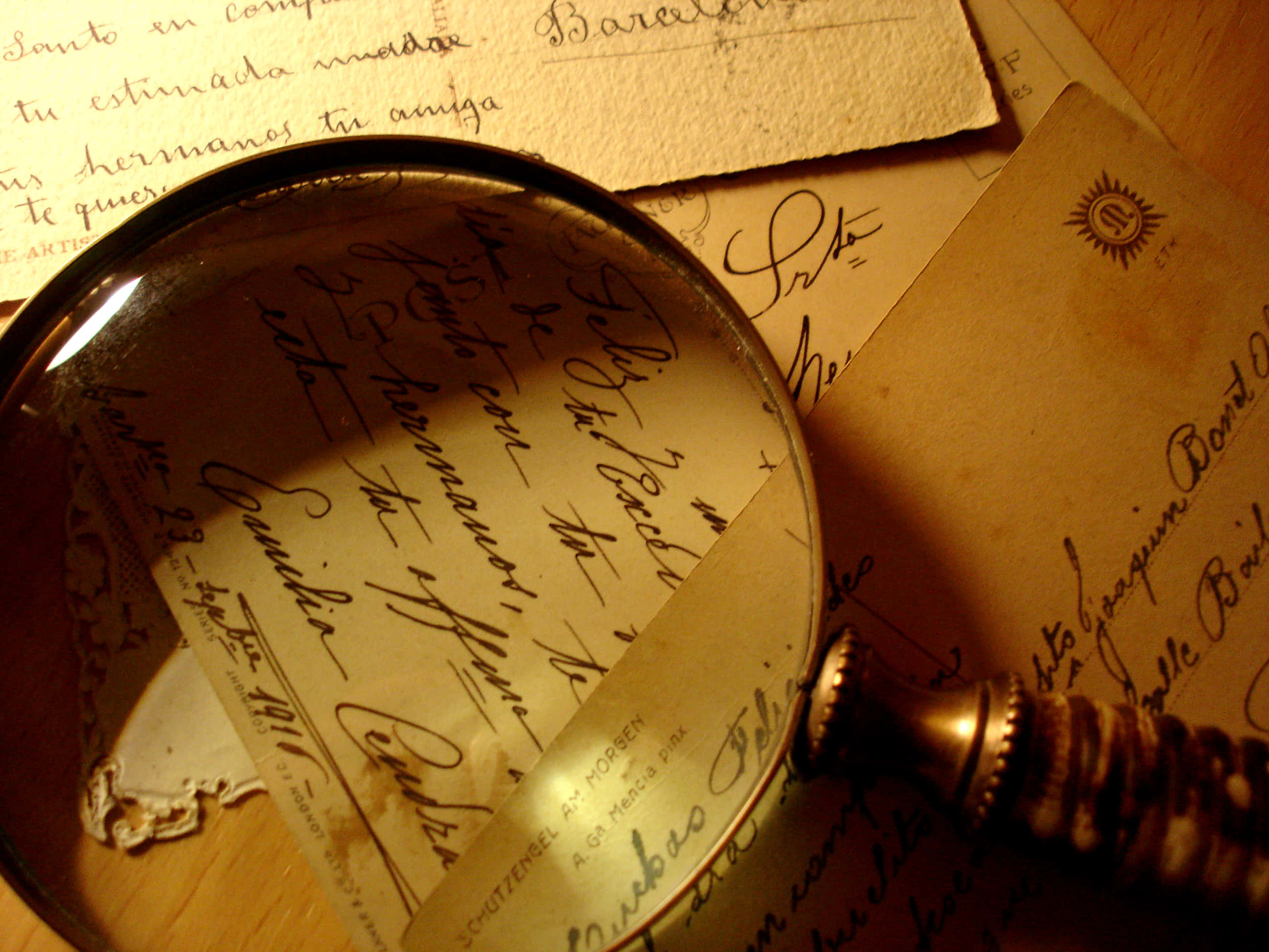 vintage magnifying glass, aged handwritten letters, warm golden light, 2K Desktop Wallpaper