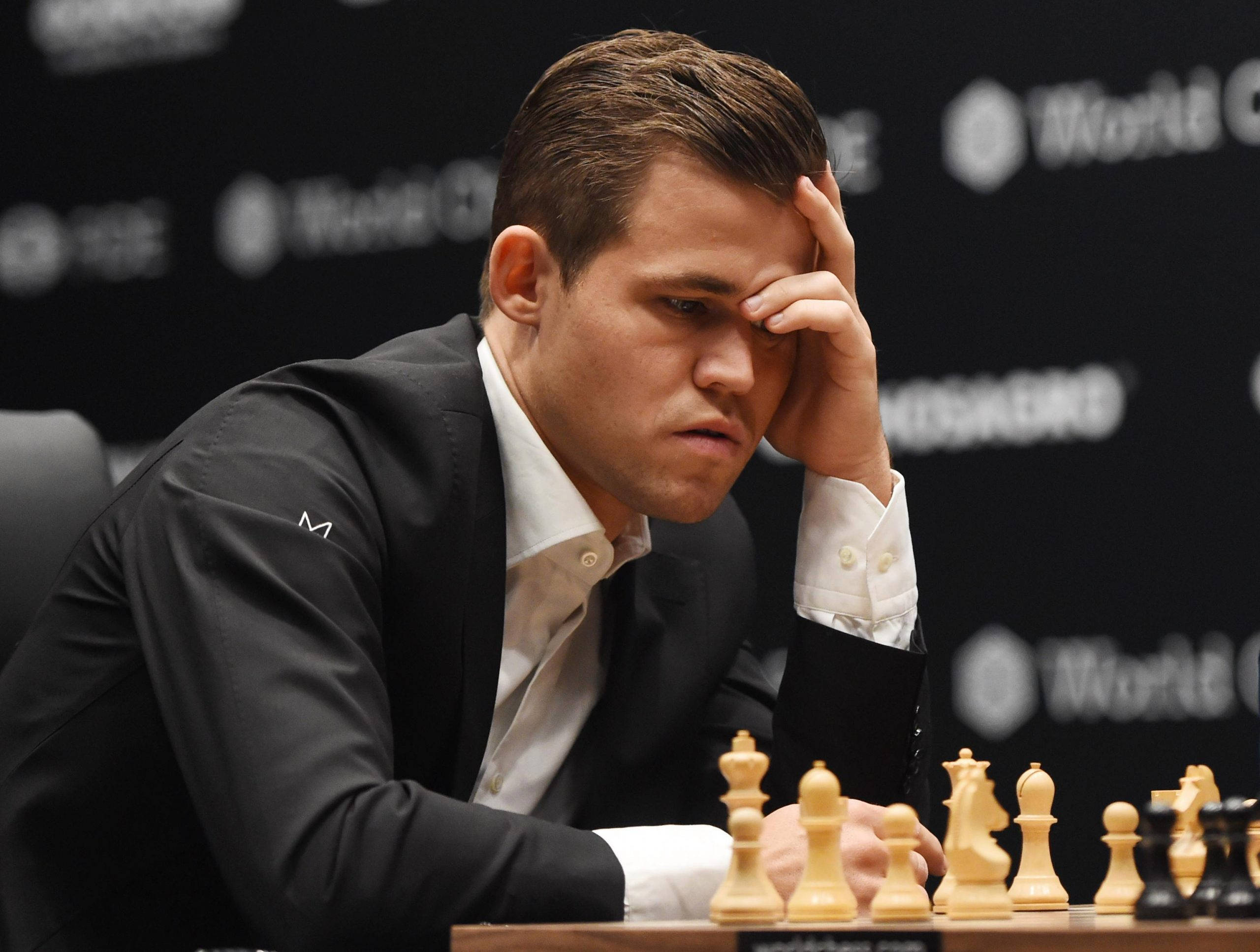 Magnus Carlsen, black suit, chessboard, 2K Desktop Wallpaper