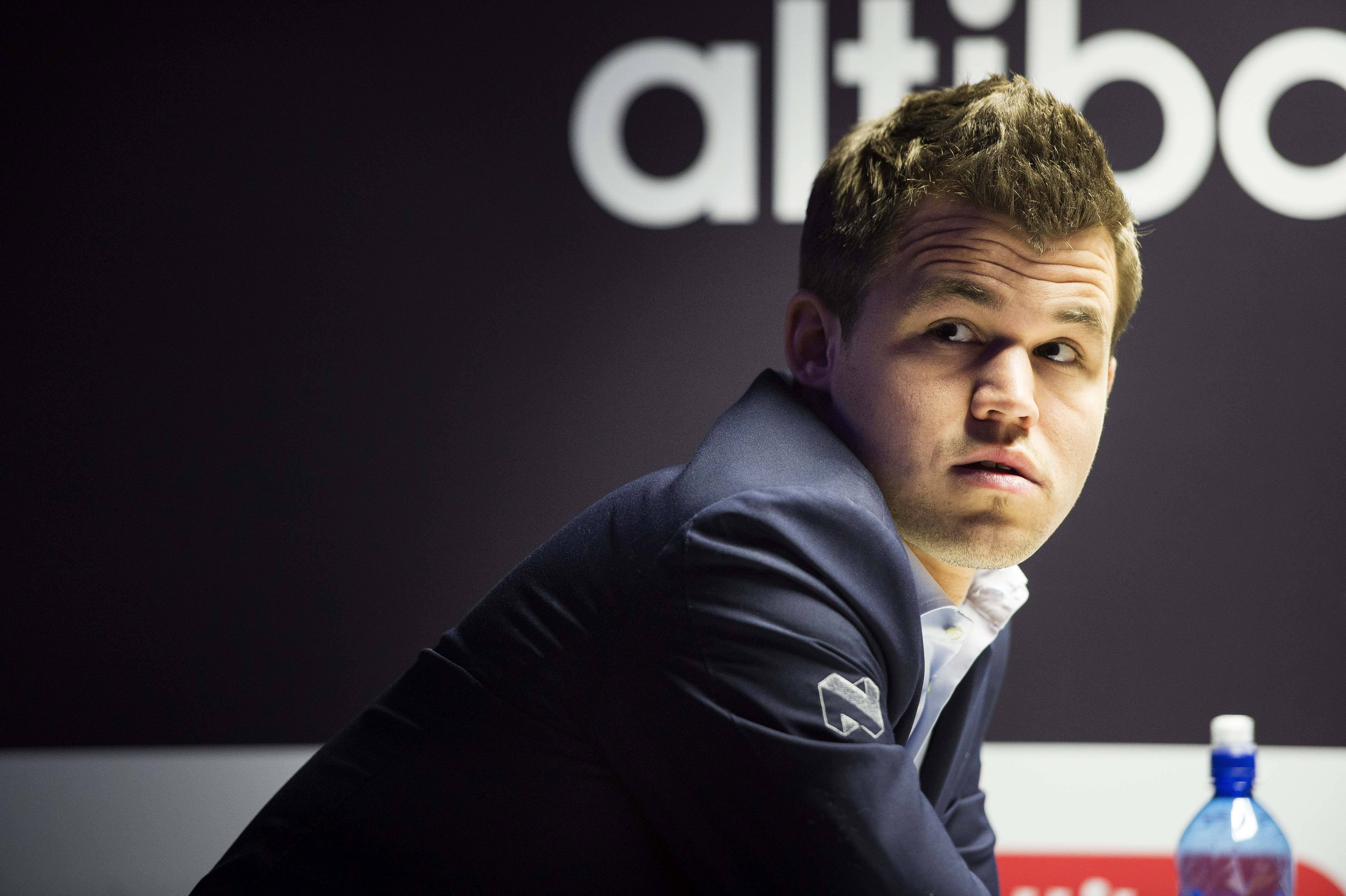 Magnus Carlsen, dark suit, serious expression, 4K Desktop Wallpaper