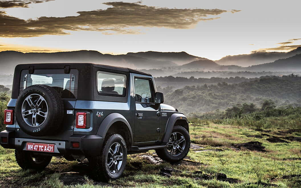 Mahindra Scorpio, rugged black SUV, grassy terrain, SD Desktop Wallpaper