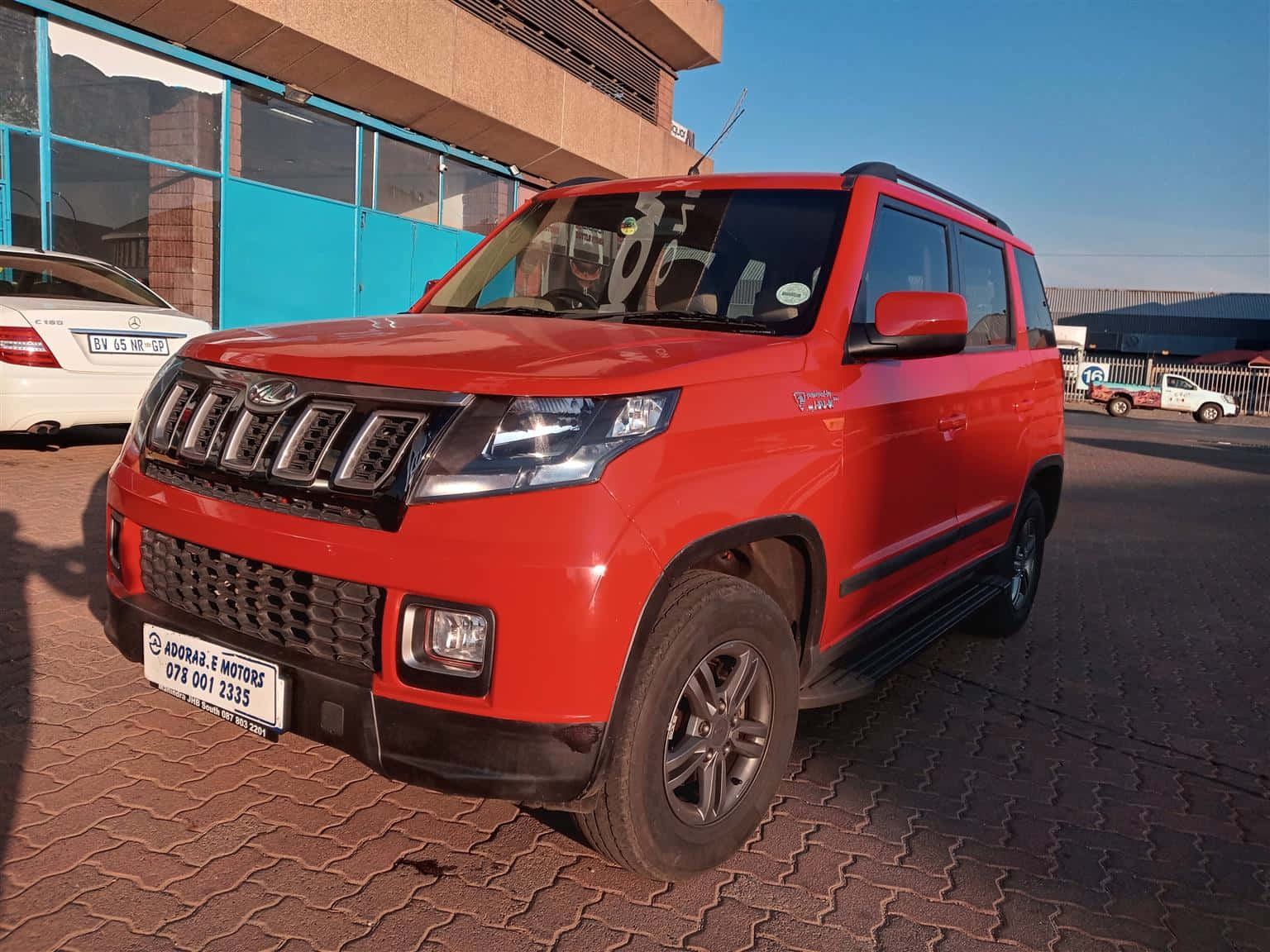 Red Mahindra TUV300, parked outdoors, patterned brick lot, HD Desktop Wallpaper