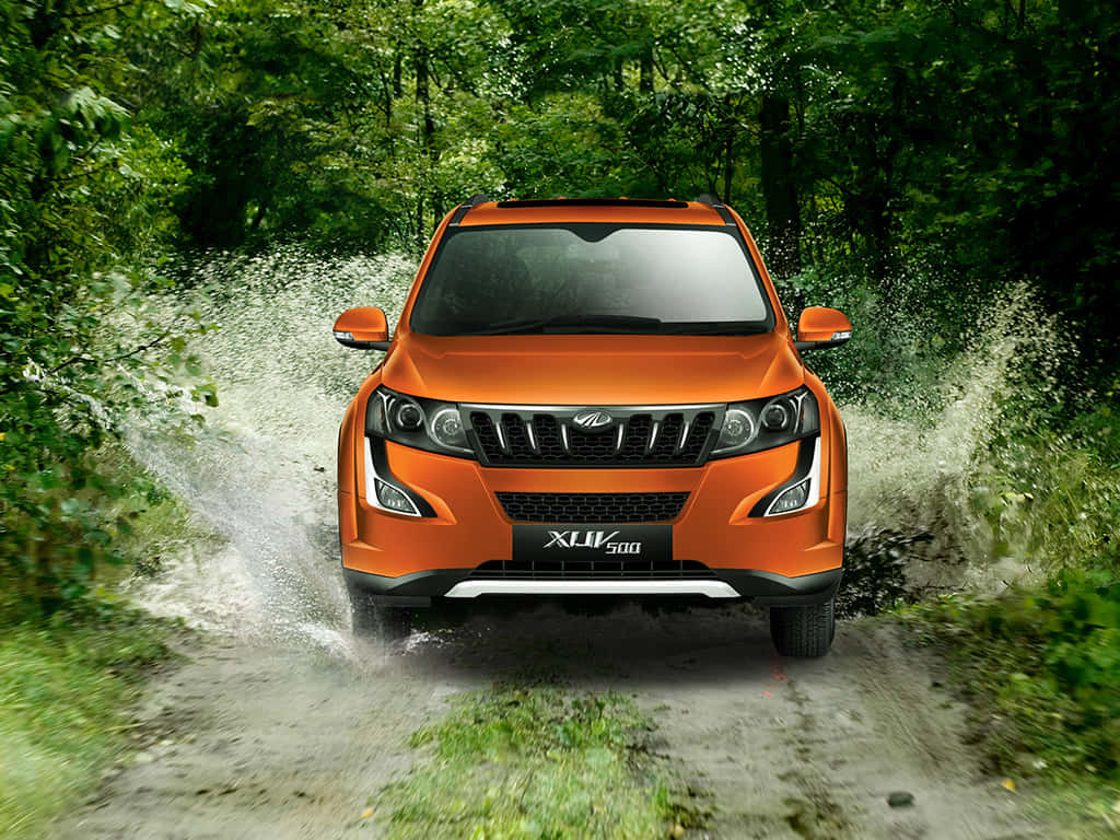 Mahindra XUV500, vibrant orange, muddy forest trail, SD Desktop Wallpaper