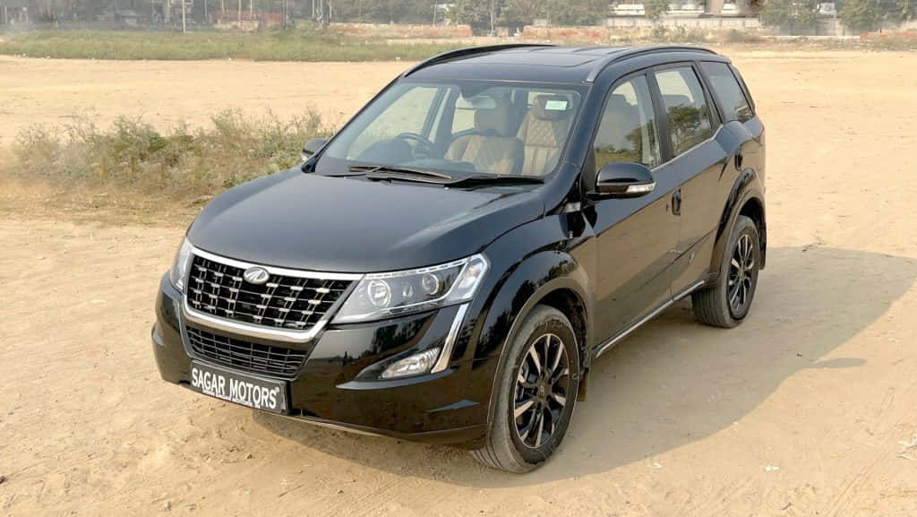 Mahindra XUV500, sleek black SUV, dry sandy terrain, SD Desktop Wallpaper