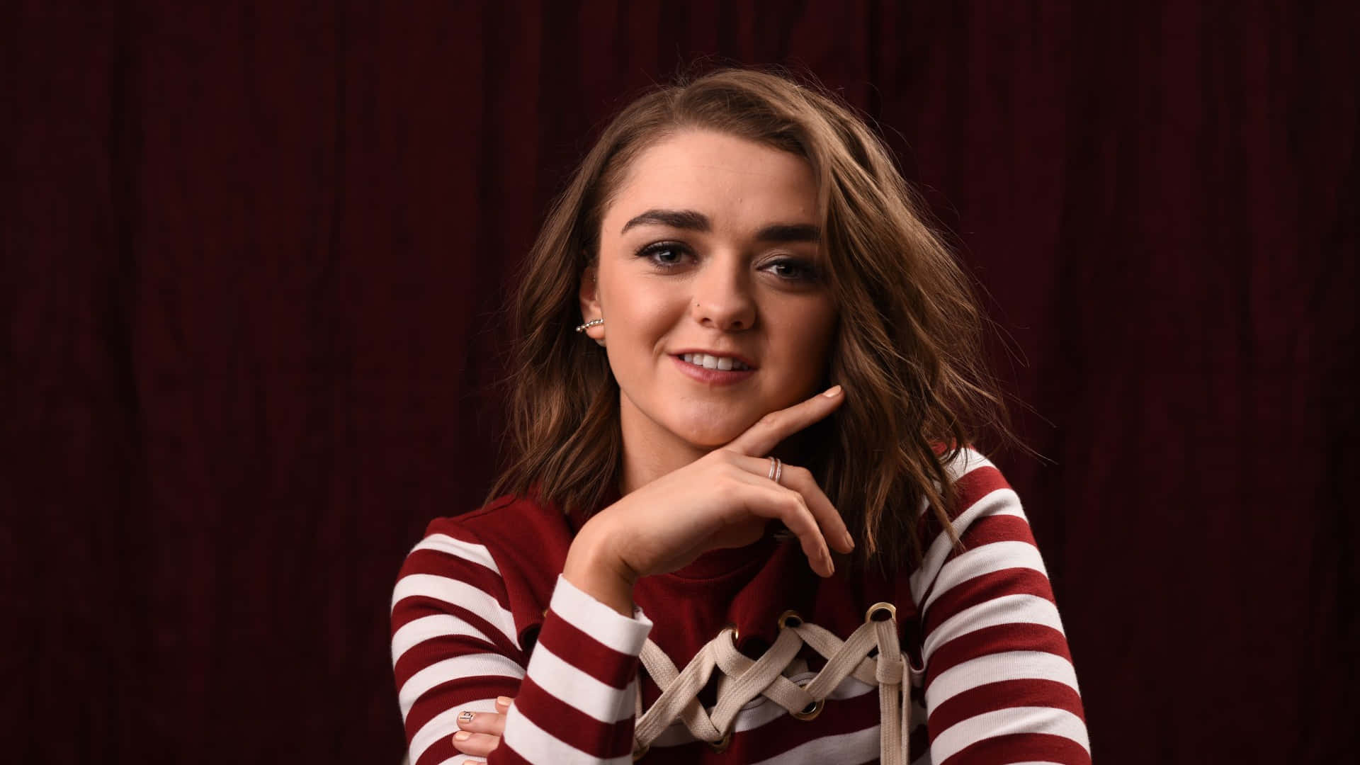 Maisie Williams, wavy brown hair, deep red curtain backdrop, Full HD Desktop Wallpaper