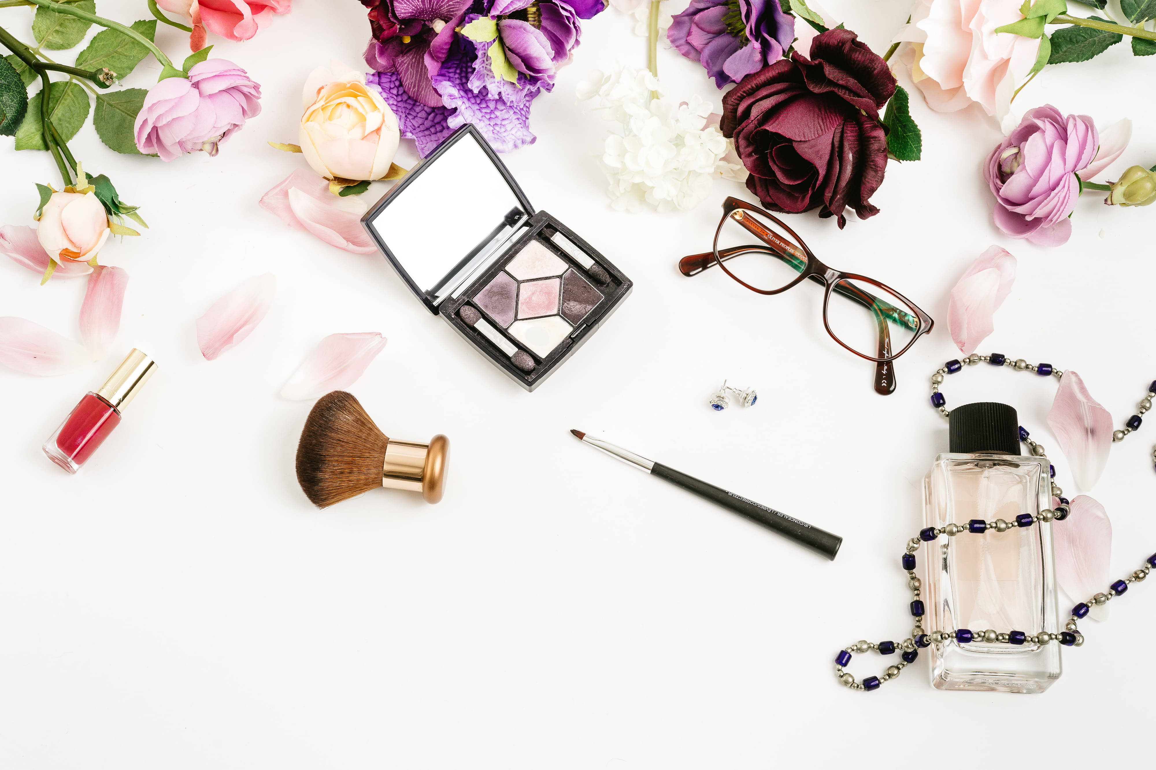 makeup items, colorful flowers, white surface, 4K Desktop Wallpaper